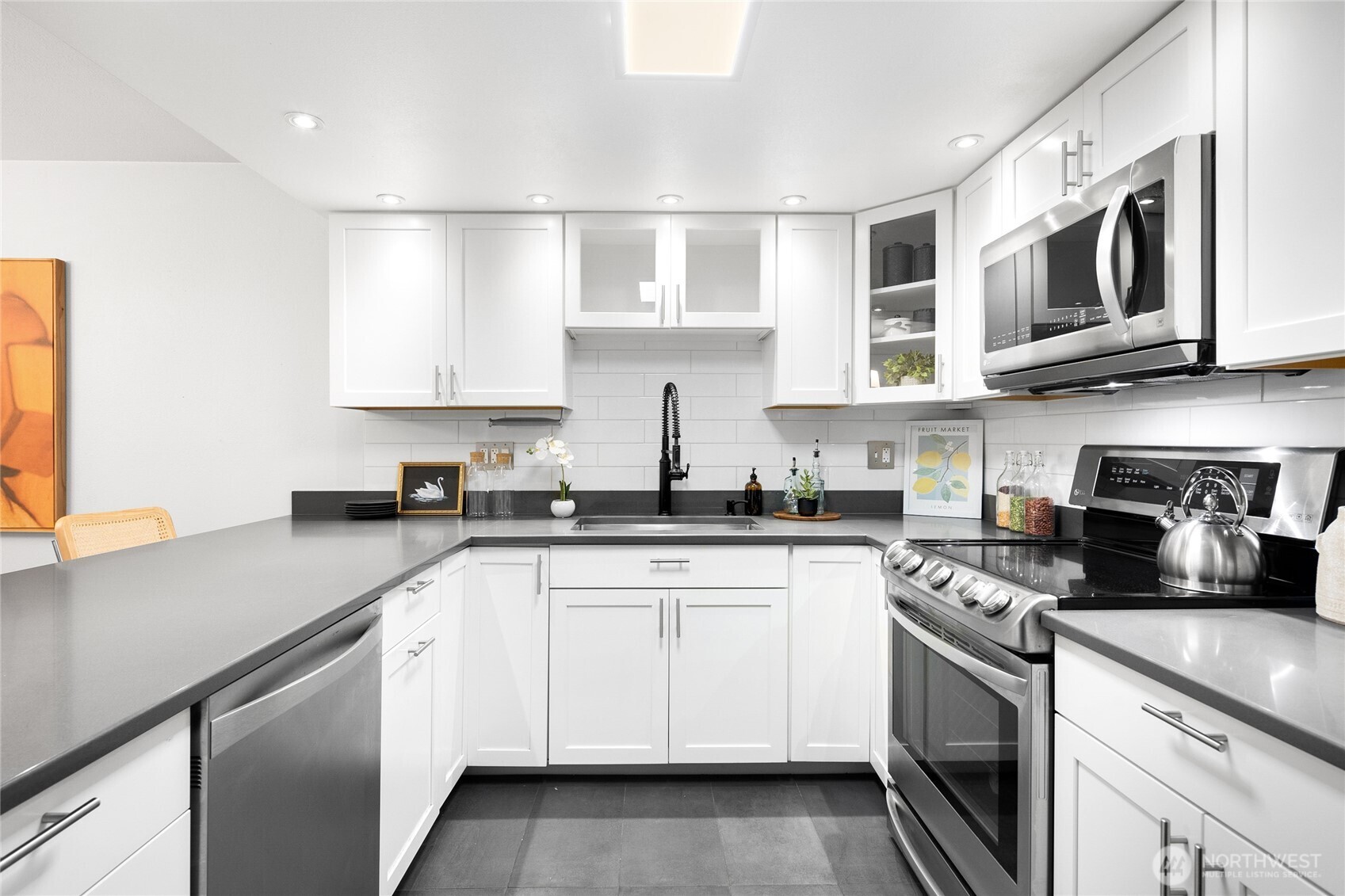 Beautifully updated kitchen with quartz countertops, and designated pantry.