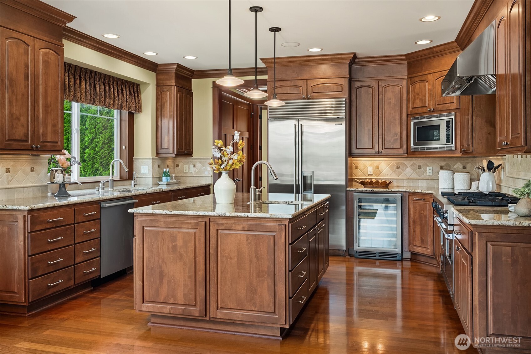 Equipped for everything from weeknight meals to holiday entertaining, the chef's kitchen features a professional-style range, oversized island, abundant prep space, and extensive custom cabinetry.