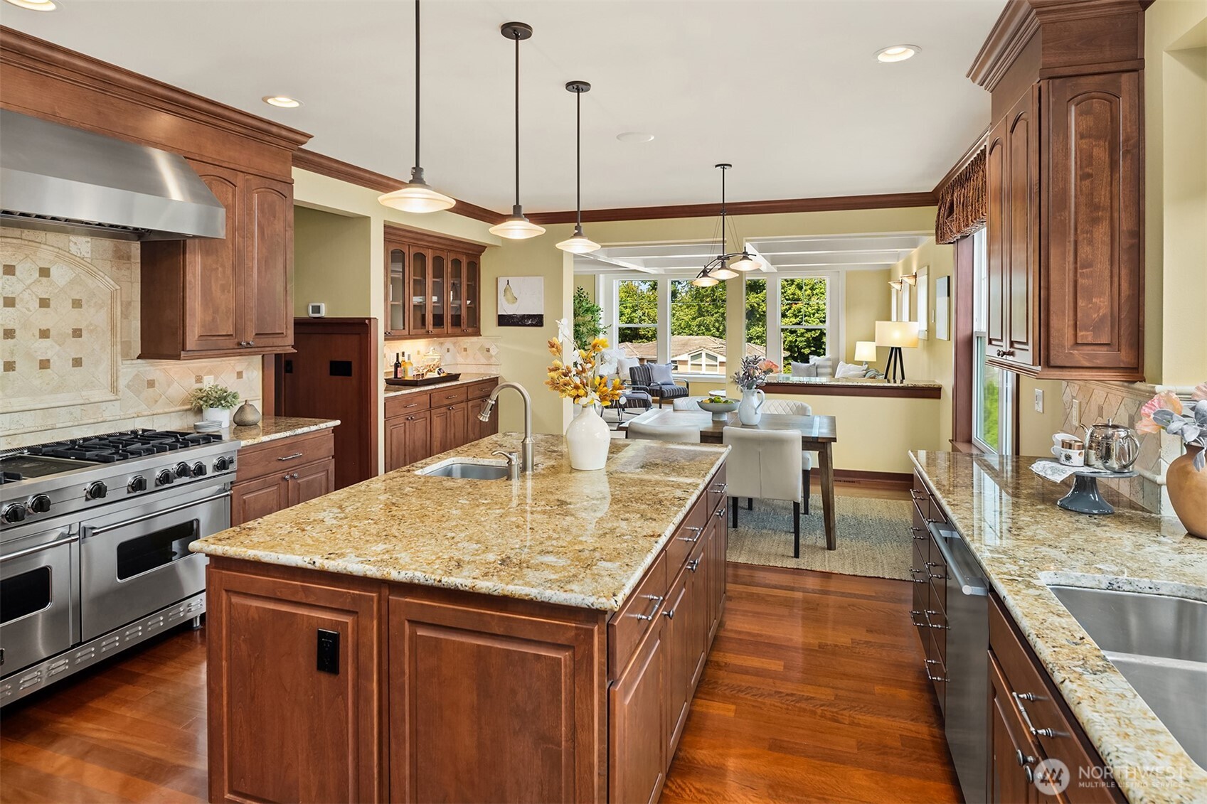 The heart of the home, where the chef's kitchen and sunlit breakfast area create an inviting space for everything from quiet mornings to lively gatherings.