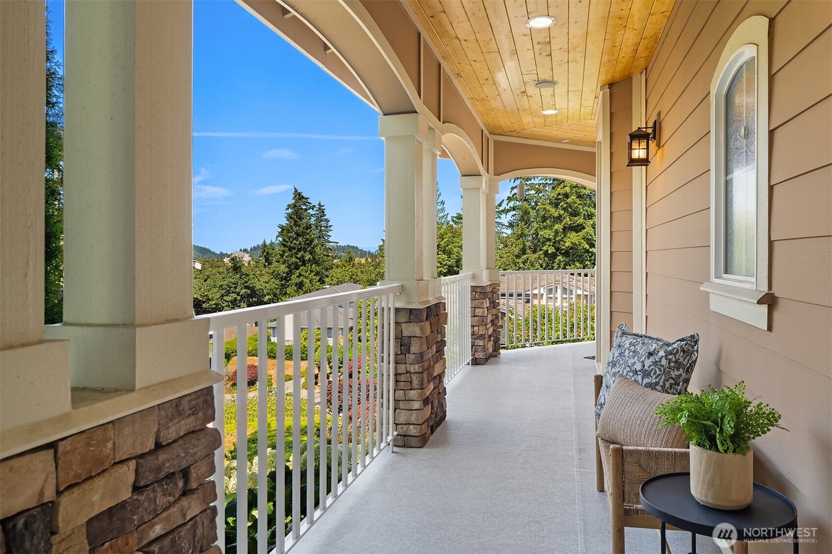 An expansive covered front wrap-around porch provides the perfect place to relax and enjoy the peaceful surroundings with views toward the neighborhood and beyond.