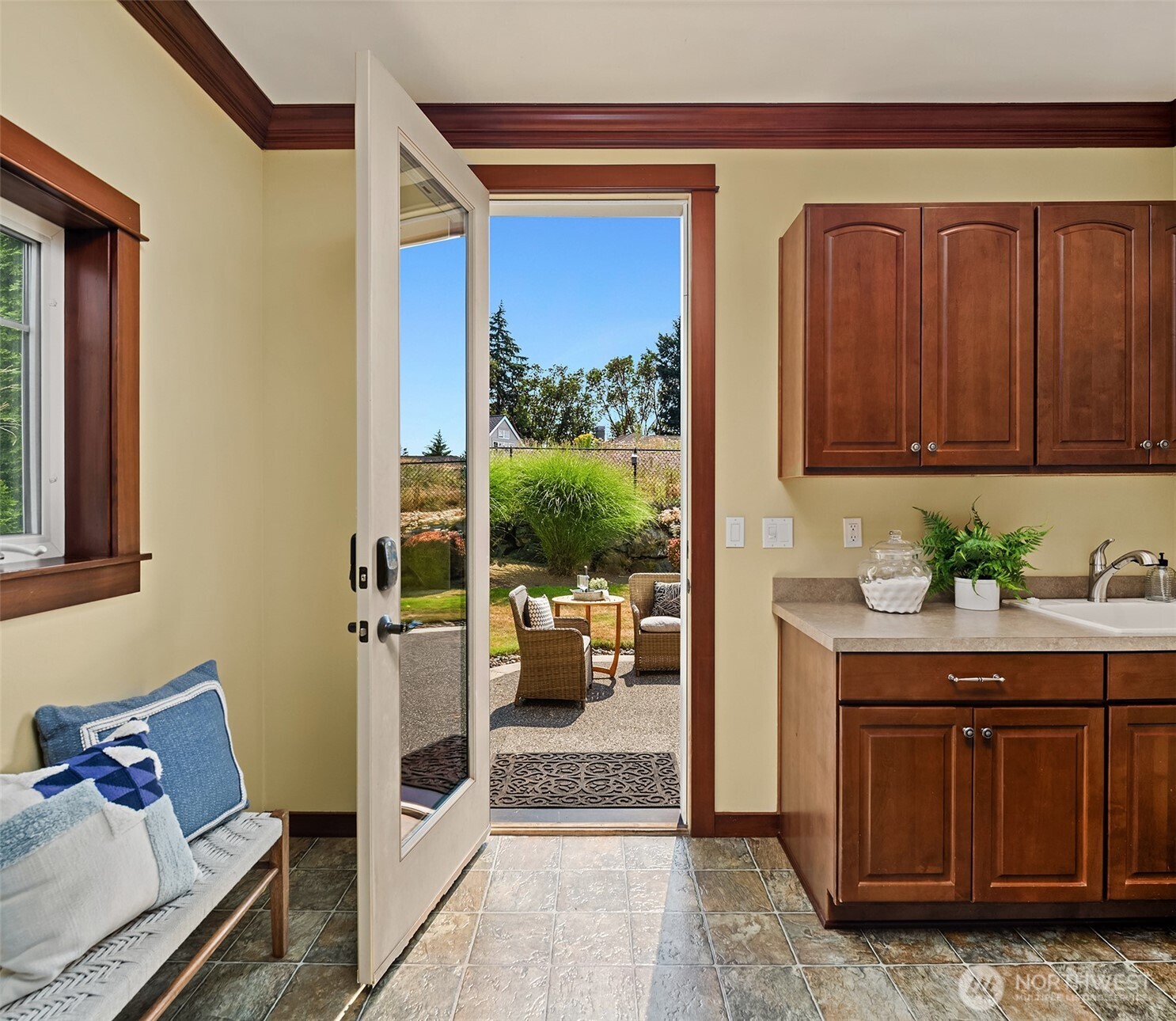 Conveniently located off the kitchen, the mudroom provides direct access to the backyard, making indoor-outdoor living and everyday routines feel seamless.