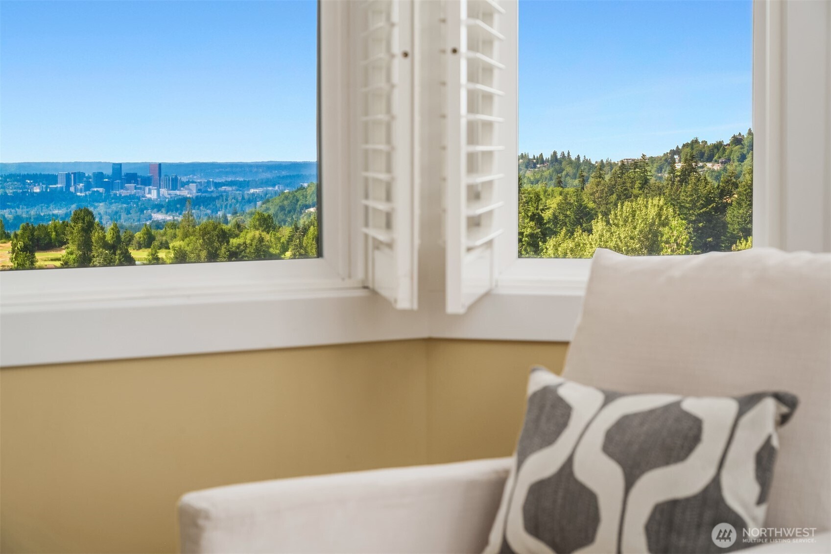A wall of windows frames picturesque outlooks, bringing natural light and distant views into the heart of the primary retreat.