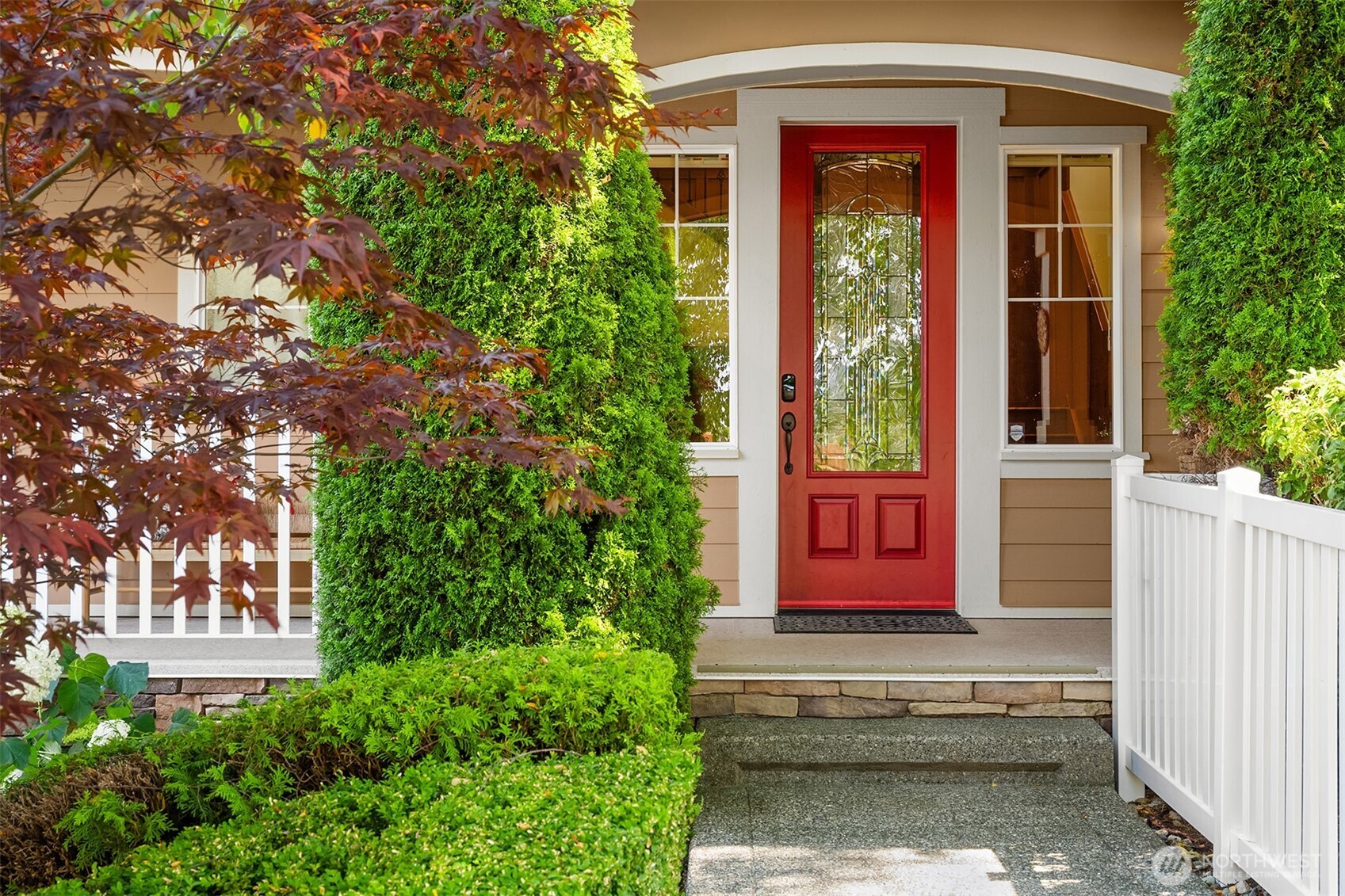 The inviting front entry combines classic Craftsman character with beautifully maintained landscaping, setting the tone for the quality found throughout the home.