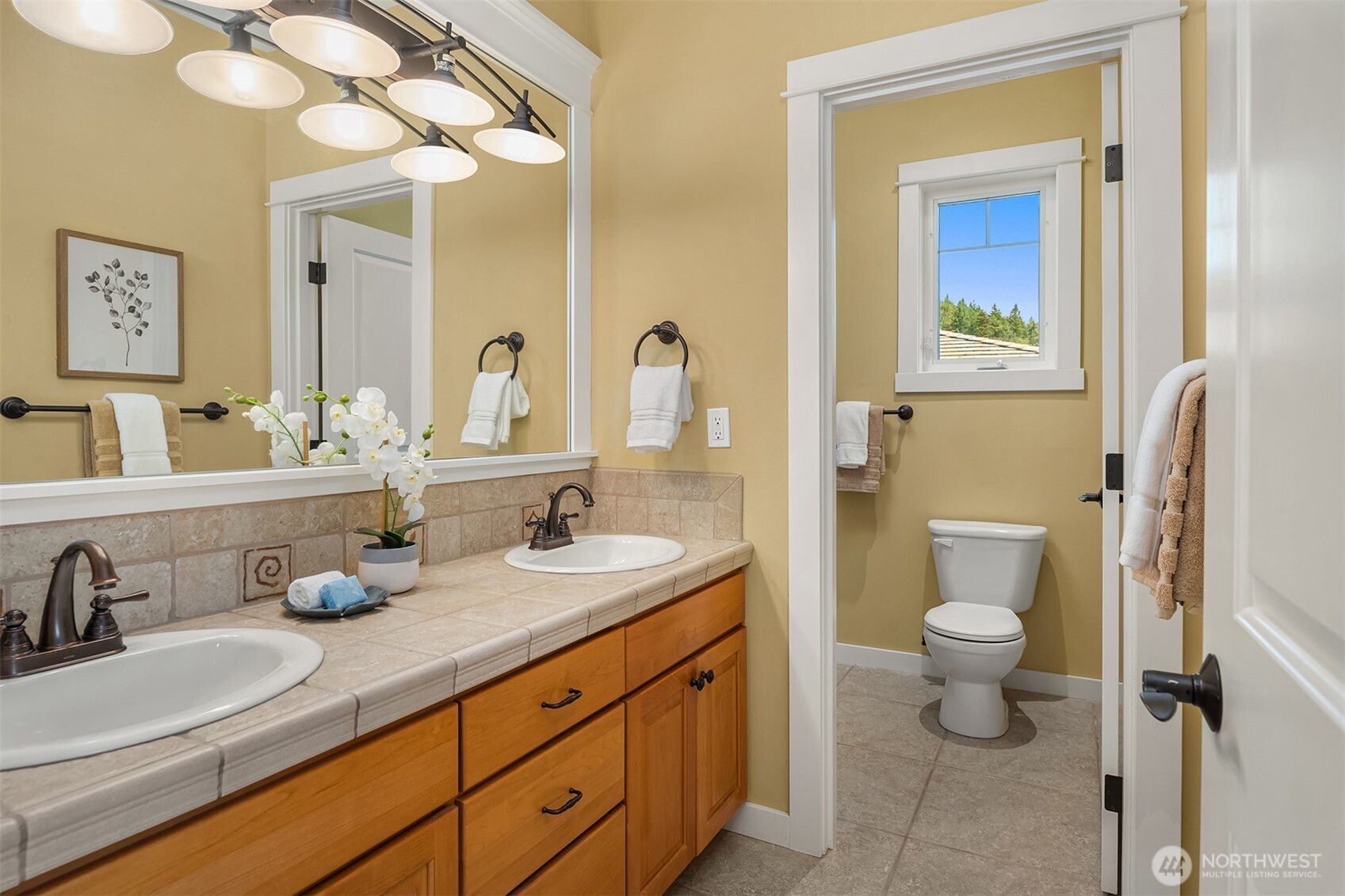 Well-appointed with dual vanities and a separate water closet, the upstairs hall bath is thoughtfully designed to comfortably serve the secondary bedrooms.