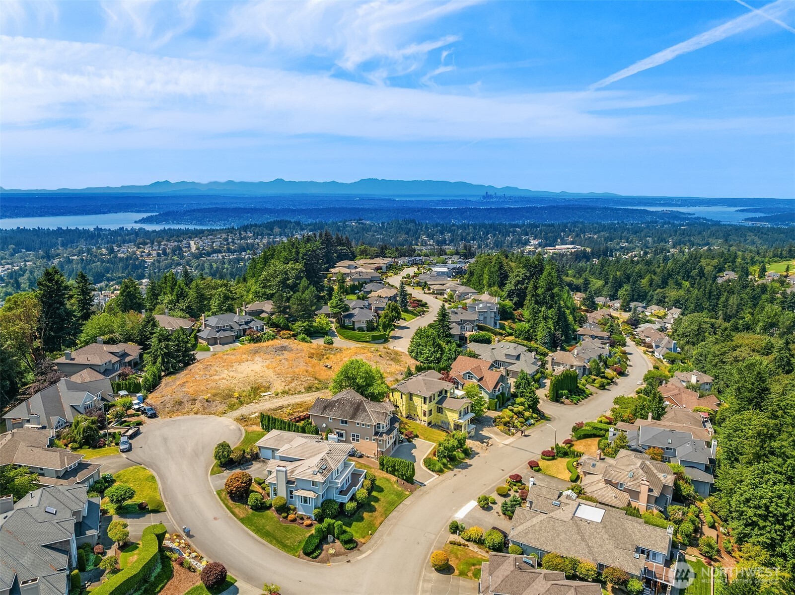 Perched near the top of one of Newcastle's most desirable neighborhoods, the home enjoys sweeping territorial vistas with glimpses of Lake Washington, the Bellevue skyline, surrounding mountains, and lush evergreen scenery. The elevated location provides both privacy and a remarkable sense of openness.