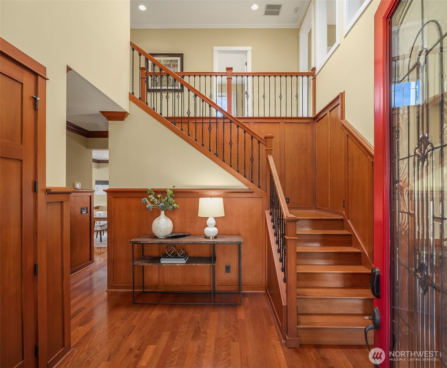 Step inside to soaring ceilings, abundant natural light, rich millwork, and warm hardwood floors that create an immediate sense of elegance and timeless craftsmanship.