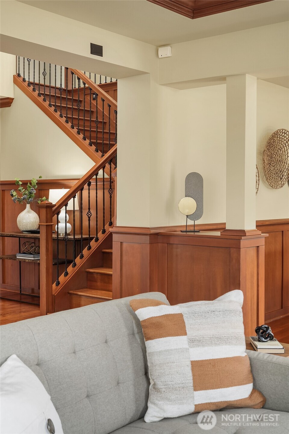 The home's central staircase serves as both a striking architectural feature and the heart of a floor plan designed for connection and comfortable living.