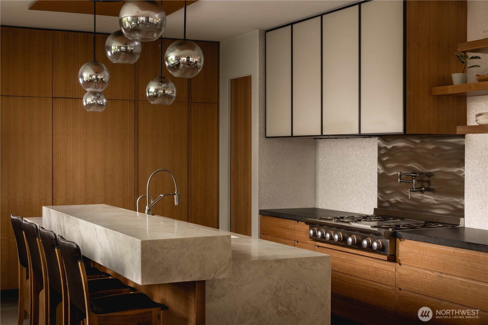 Bookmatched walnut and etched stone are executed with remarkable precision.