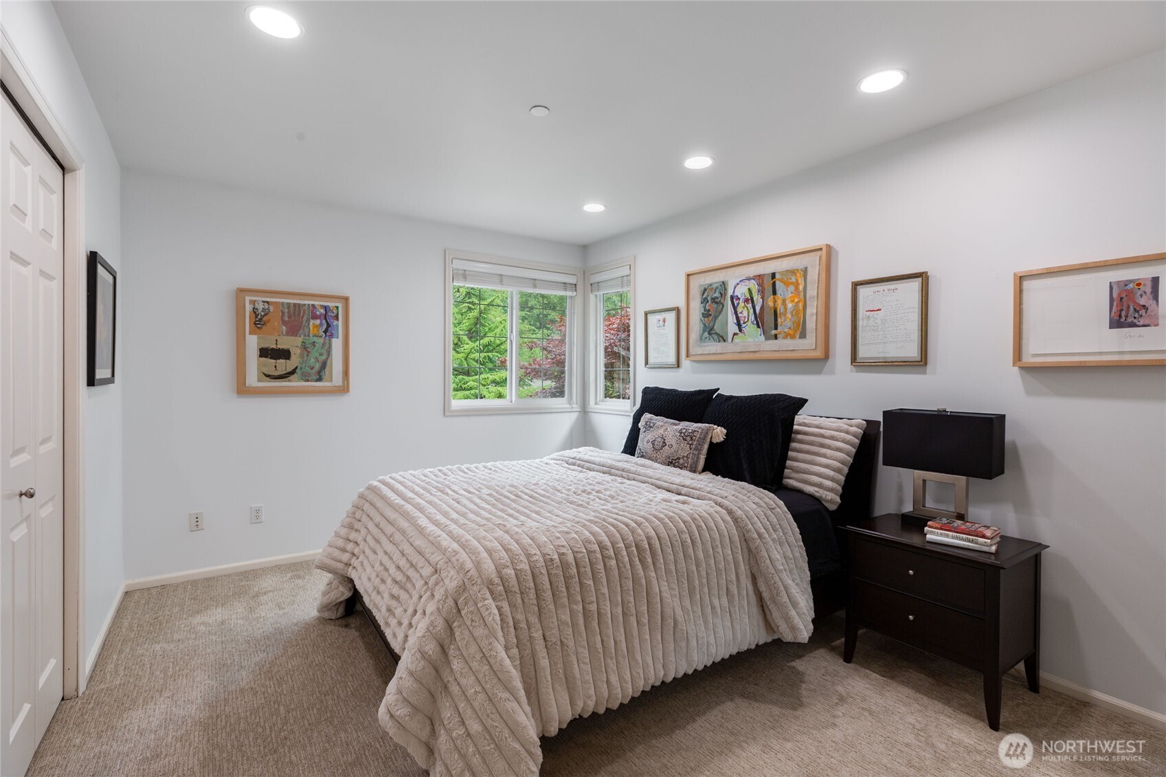 Lush, private yard with mature landscaping, manicured lawn, and serene water feature creates a peaceful retreat.