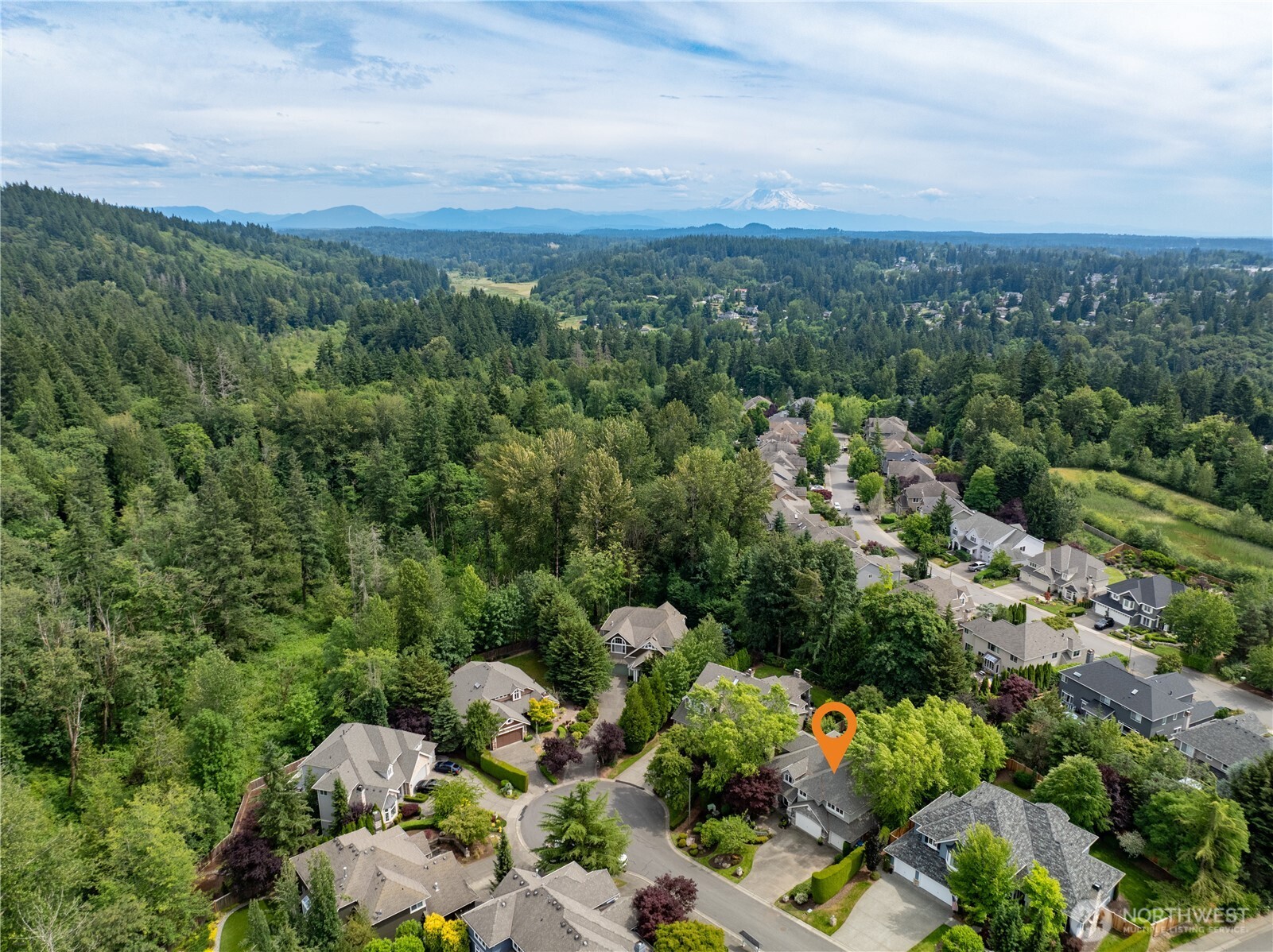 Ideally located in The Highlands at Newcastle, this home enjoys territorial views with Mount Rainier in the distance and Cougar Mountain nearby