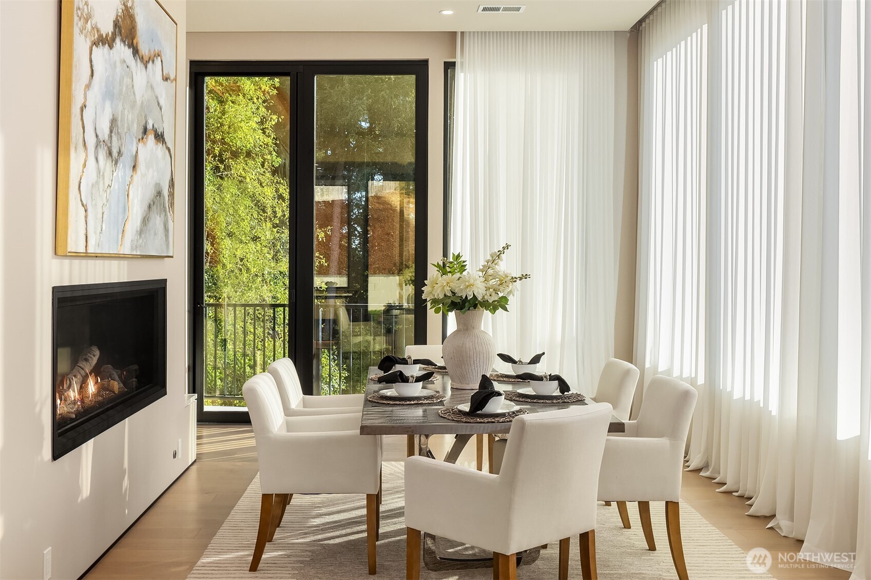 Dining room with glass fireplace + power curtains