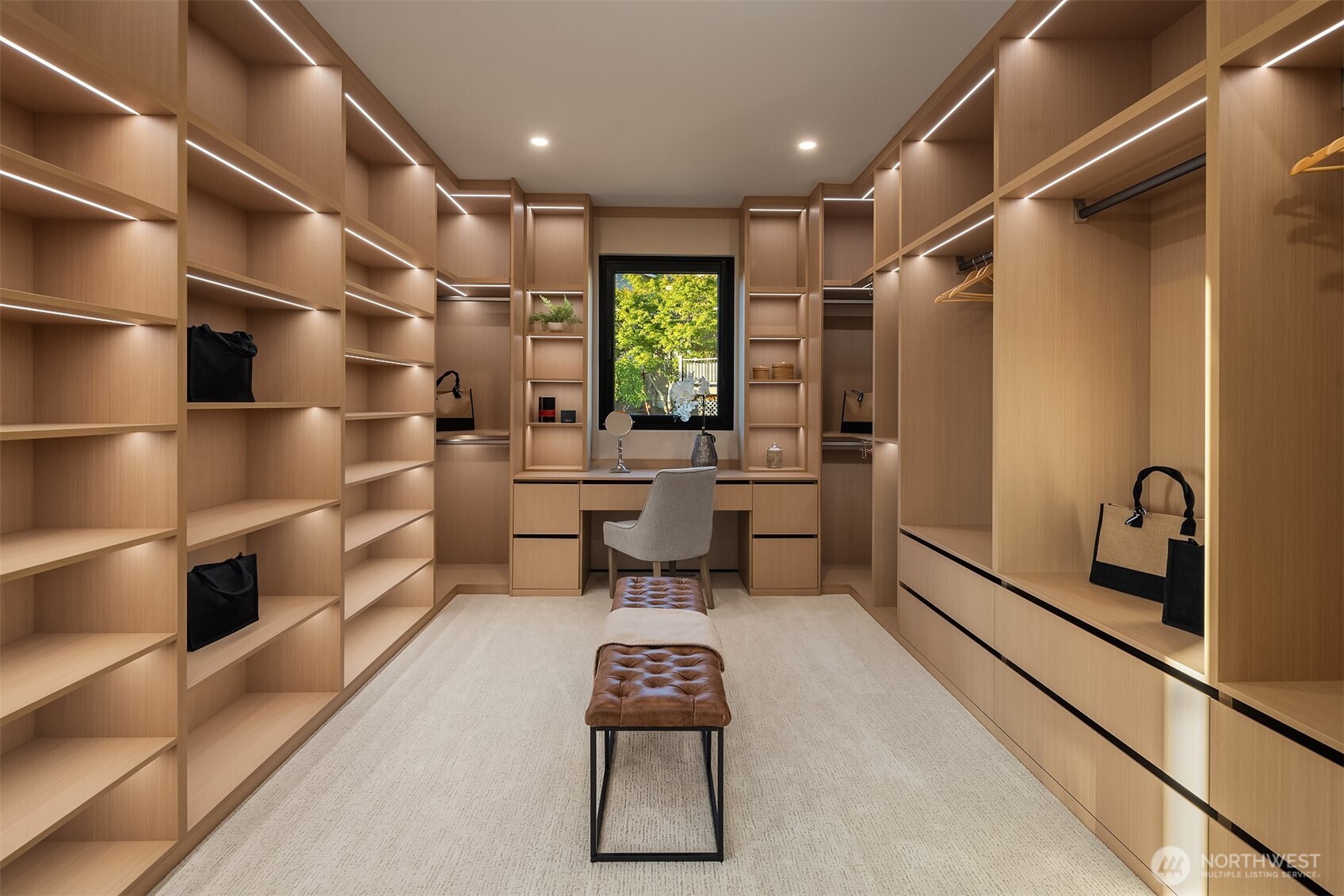 Huge primary closet with exceptional storage space and built-ins, including vanity