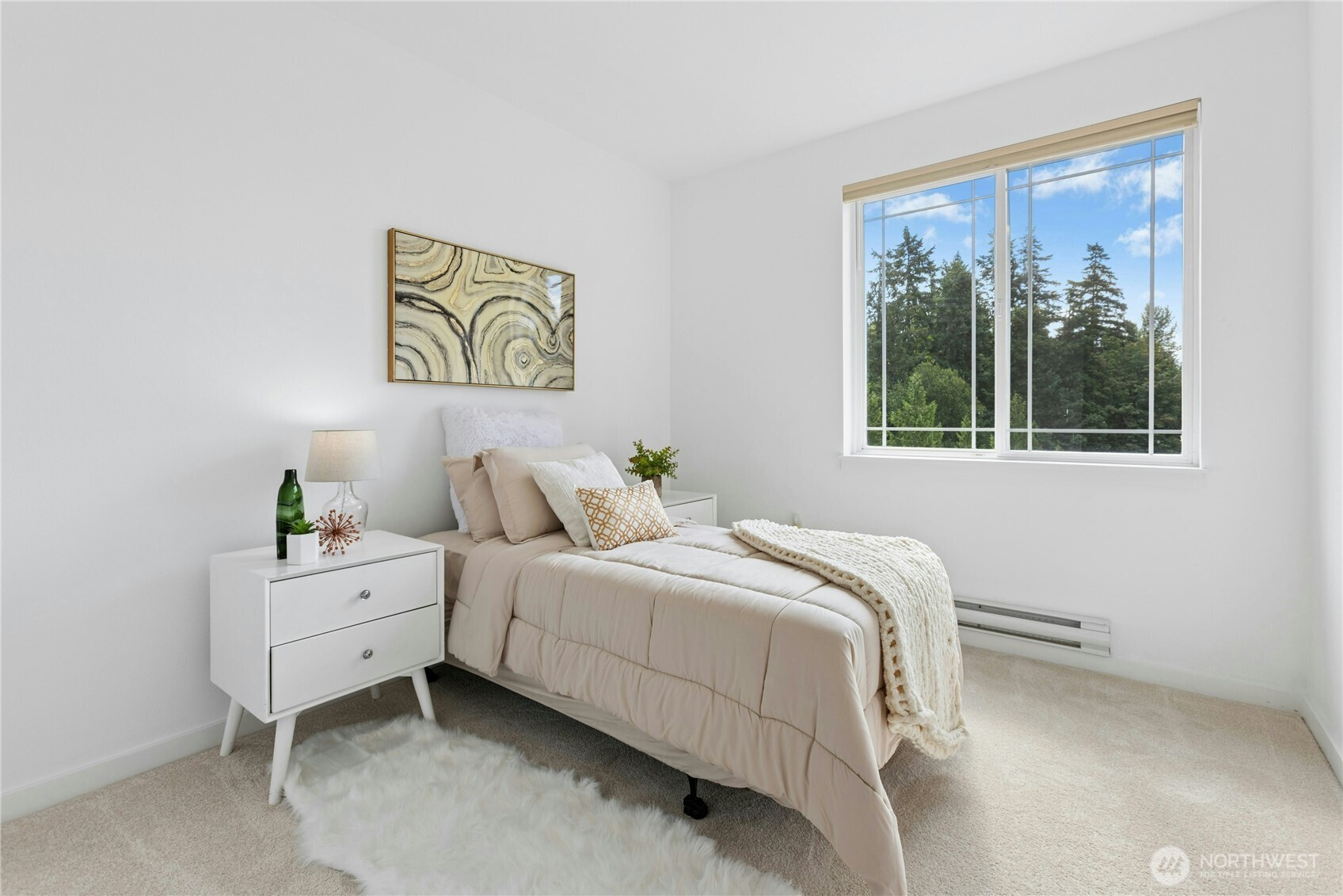 Generously sized bedroom with natural light and tranquil wooded outlook