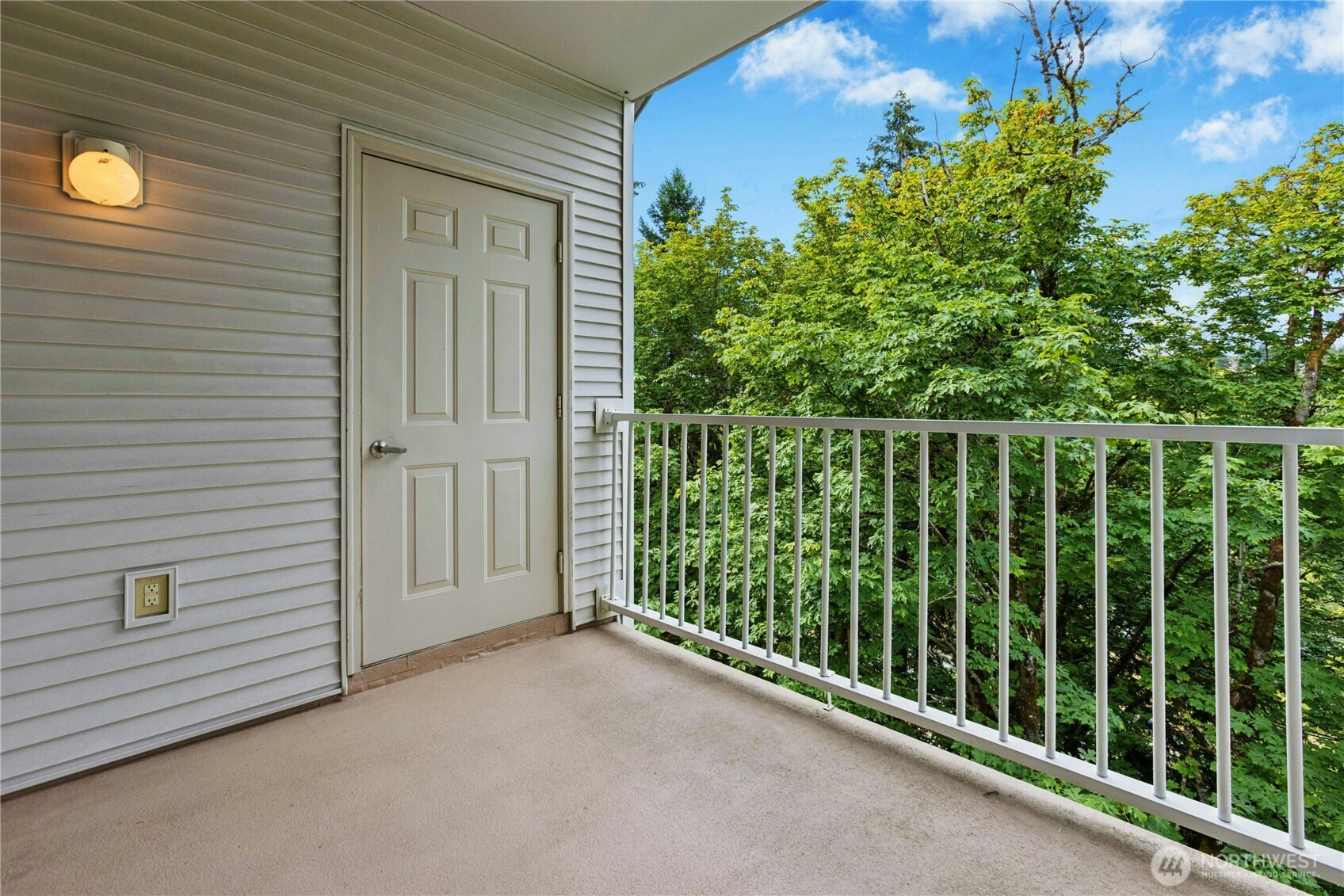 Covered balcony overlooking mature trees and tranquil natural surroundings