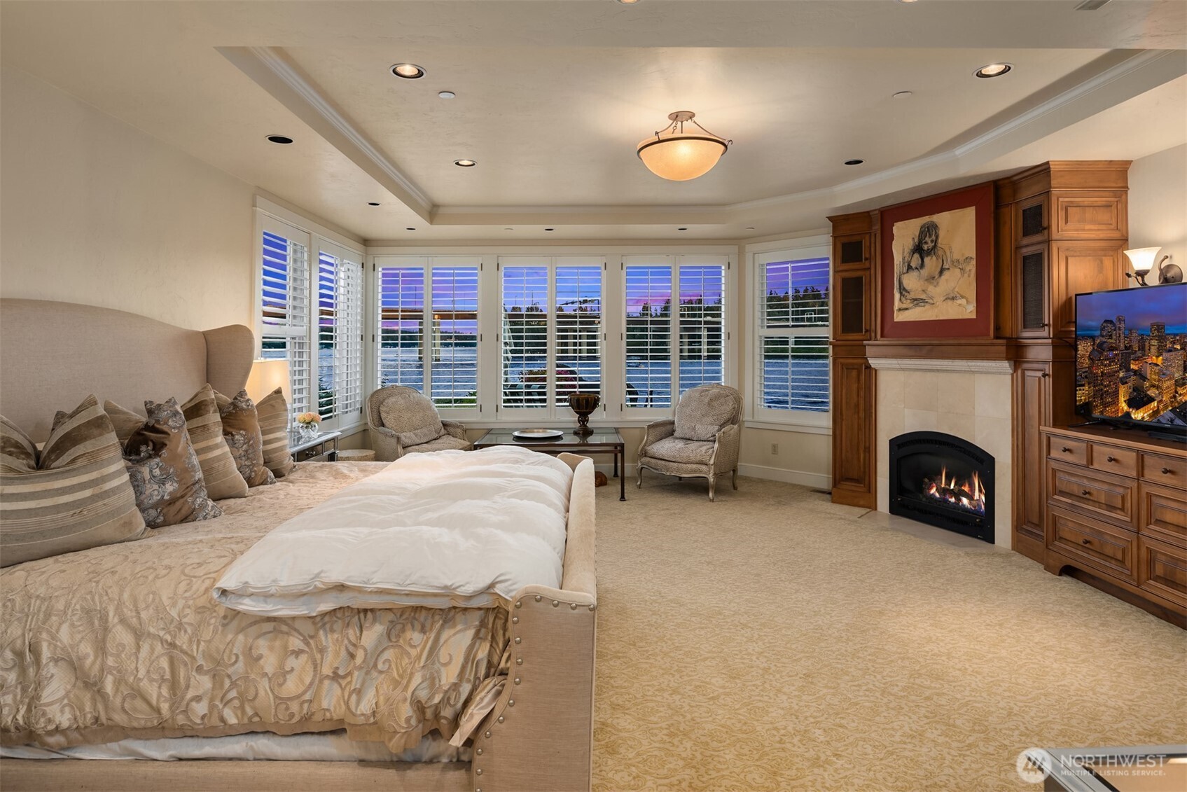 Luxurious Primary Suite has water views and a fireplace.