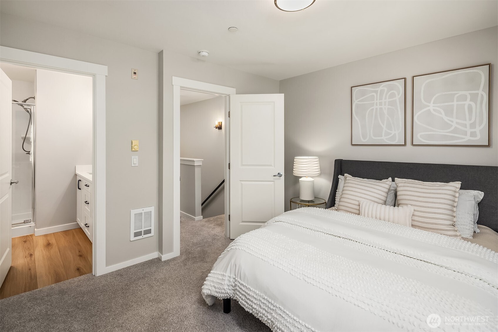 Spacious primary suite with ensuite bathroom with dual vanities. New plush carpet up the stairs and in the bedrooms. Luxury vinyl plank in both bathrooms.