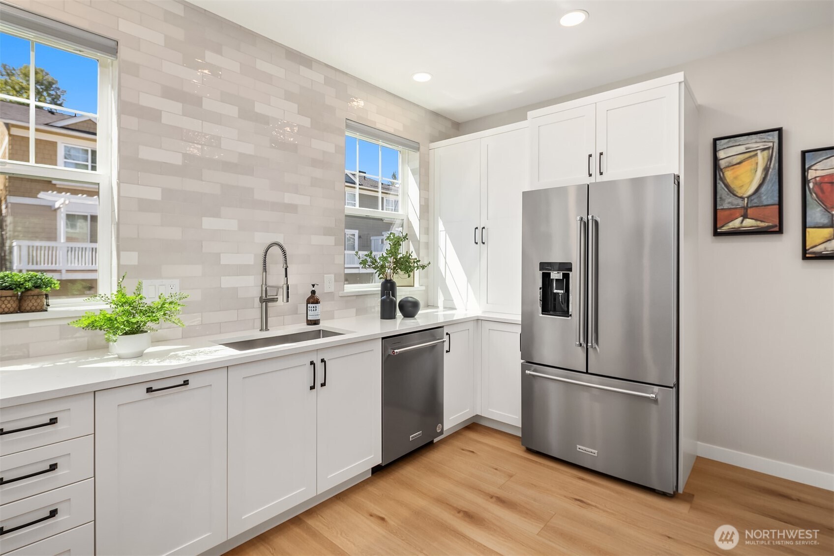 As part of the remodel, the kitchen footprint was expanded and additional cabinets added, including a double cabinet to the left of the fridge - a perfect pantry!