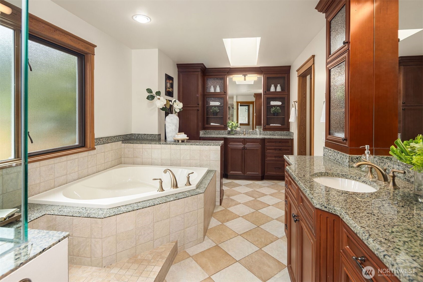 Walls of glass surround kitchen, and family room allowing lots of natural light in.