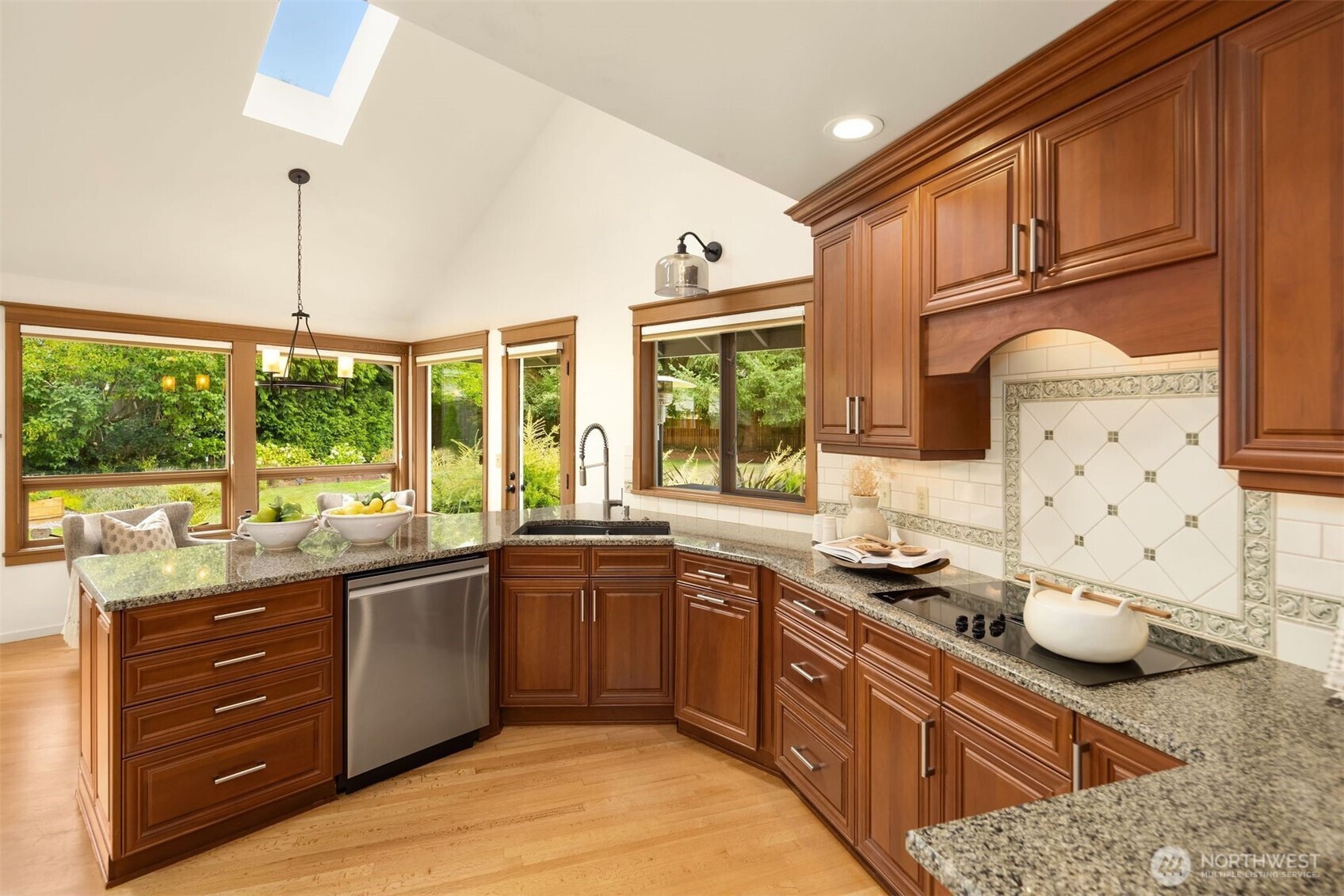 Vaulted ceiling with fan and skylights