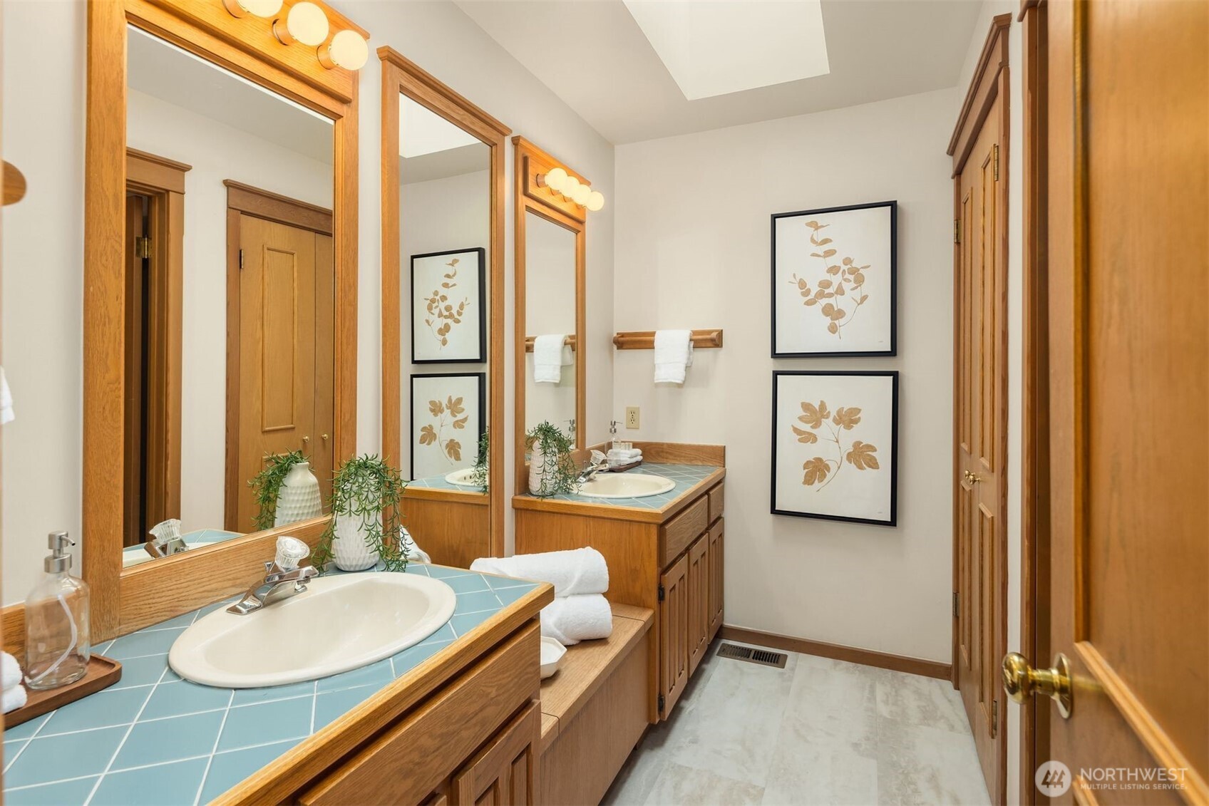 Full bathroom with double vanities on the first floor next to the bedrooms.