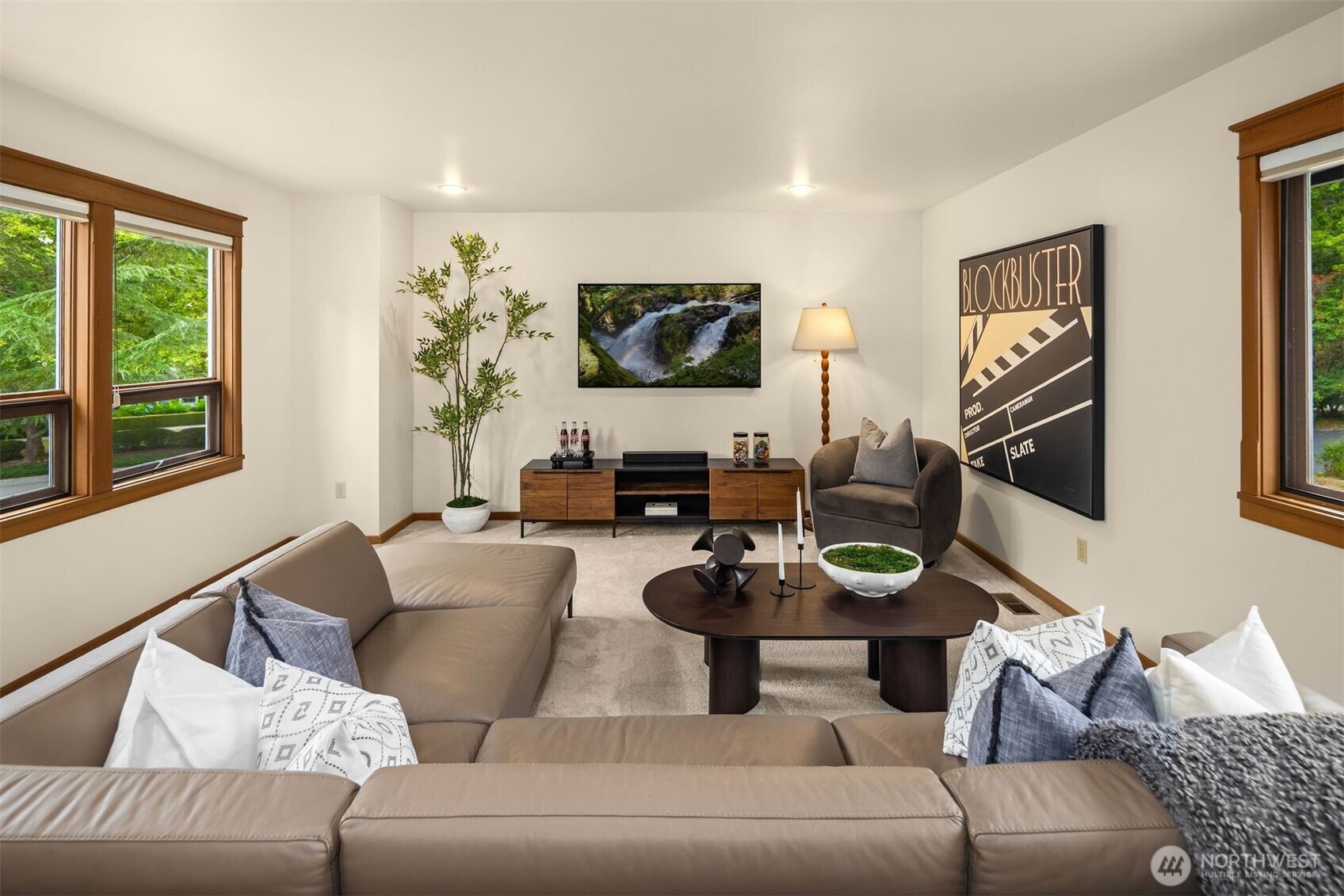 Views of the garden and a grand fireplace this living room is a warm and inviting space.