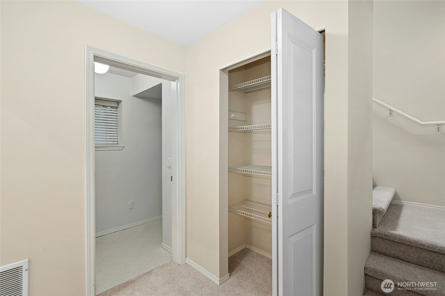 Downstairs hallway area with storage closets & utility room.