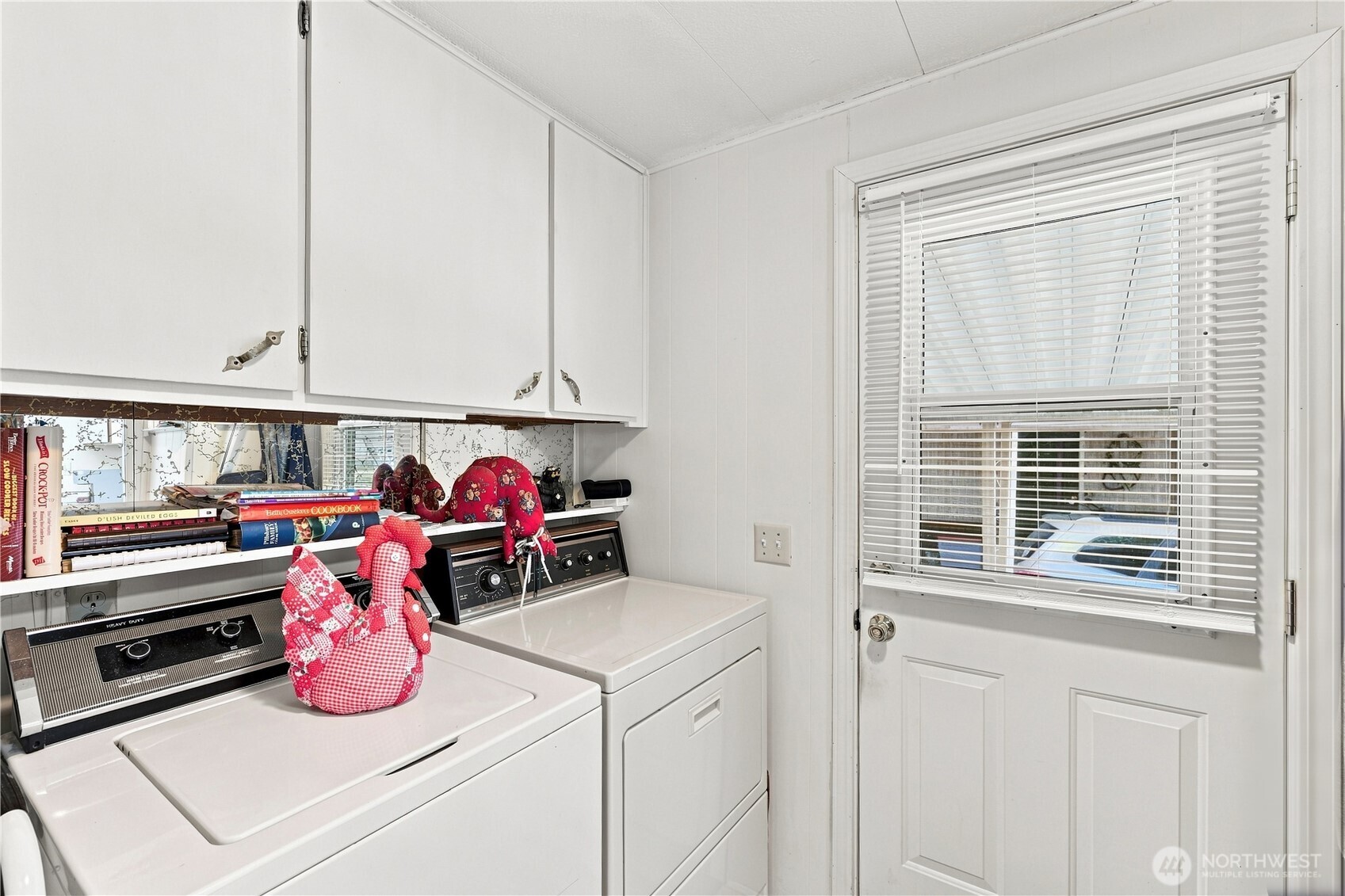 Bright, cheerful utility room goes out to the large back deck