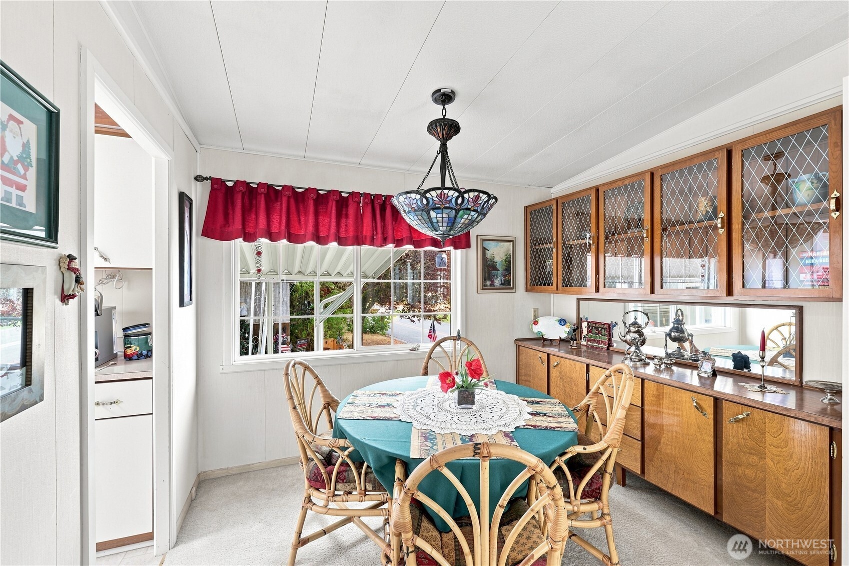 The dining area features beautiful built-in hutch and multi-pane design on dual glass windows. The Tiffany-style lamp is negotiable. It will be