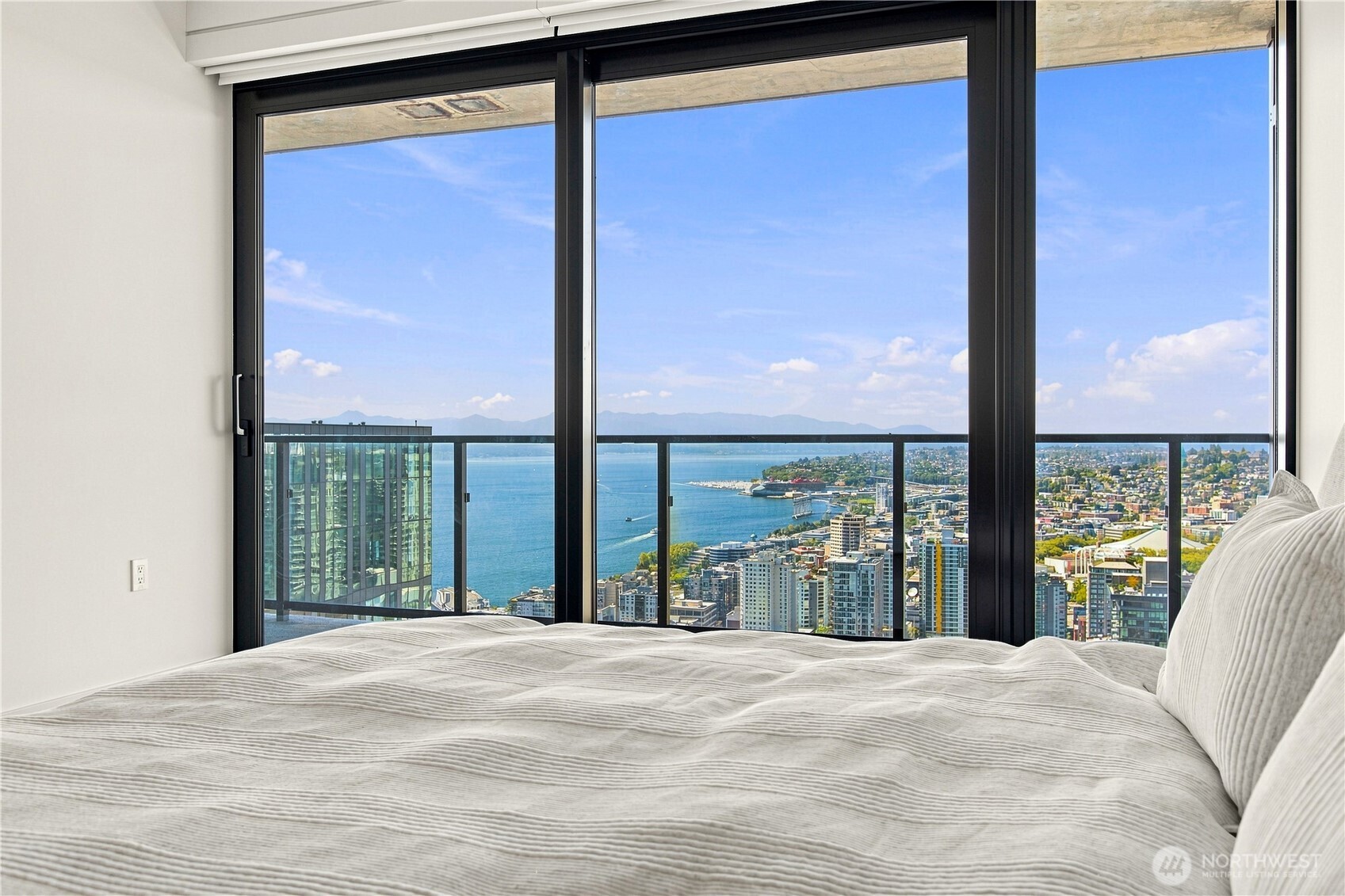 Wellness, elevated. A 46th-floor architectural sanctuary where fine art meets high-altitude fitness, framing panoramic skyline, mountain vistas, the Space Needle and glittering waterfront.