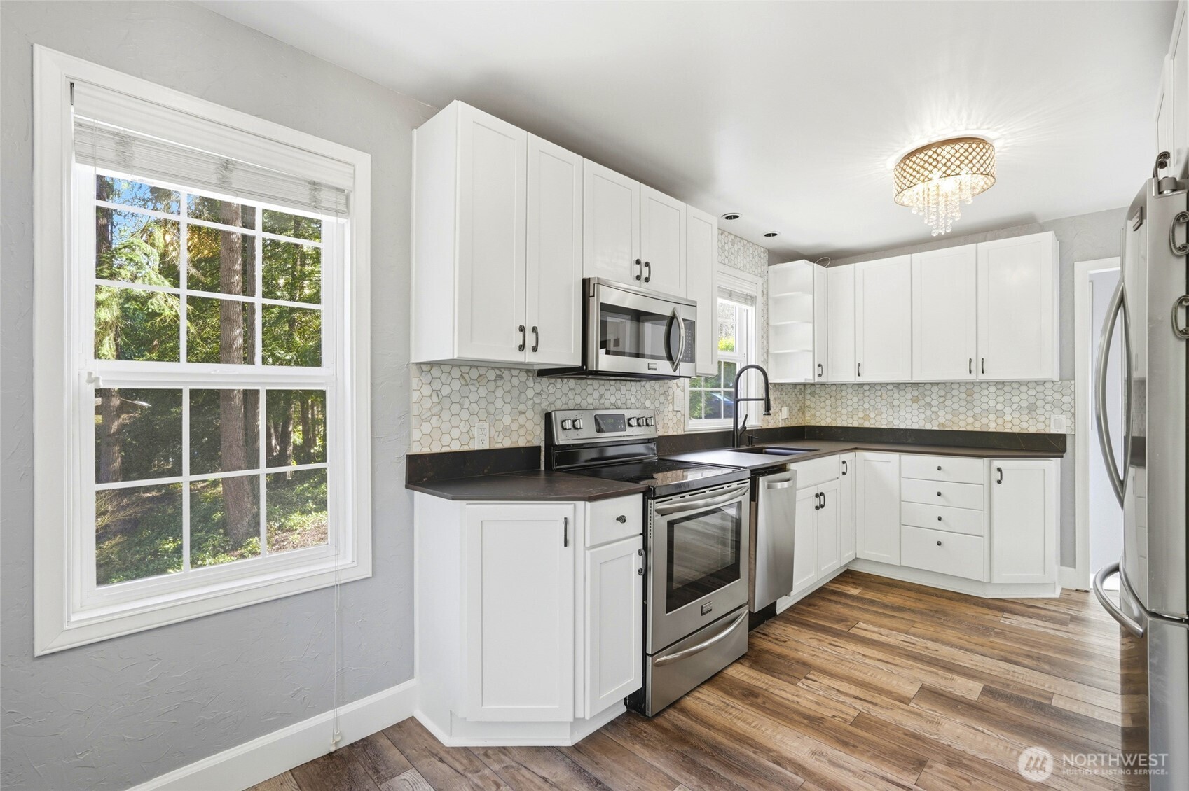 Another view of the kitchen with picture perfect windows with view, privacy and dining nook.
