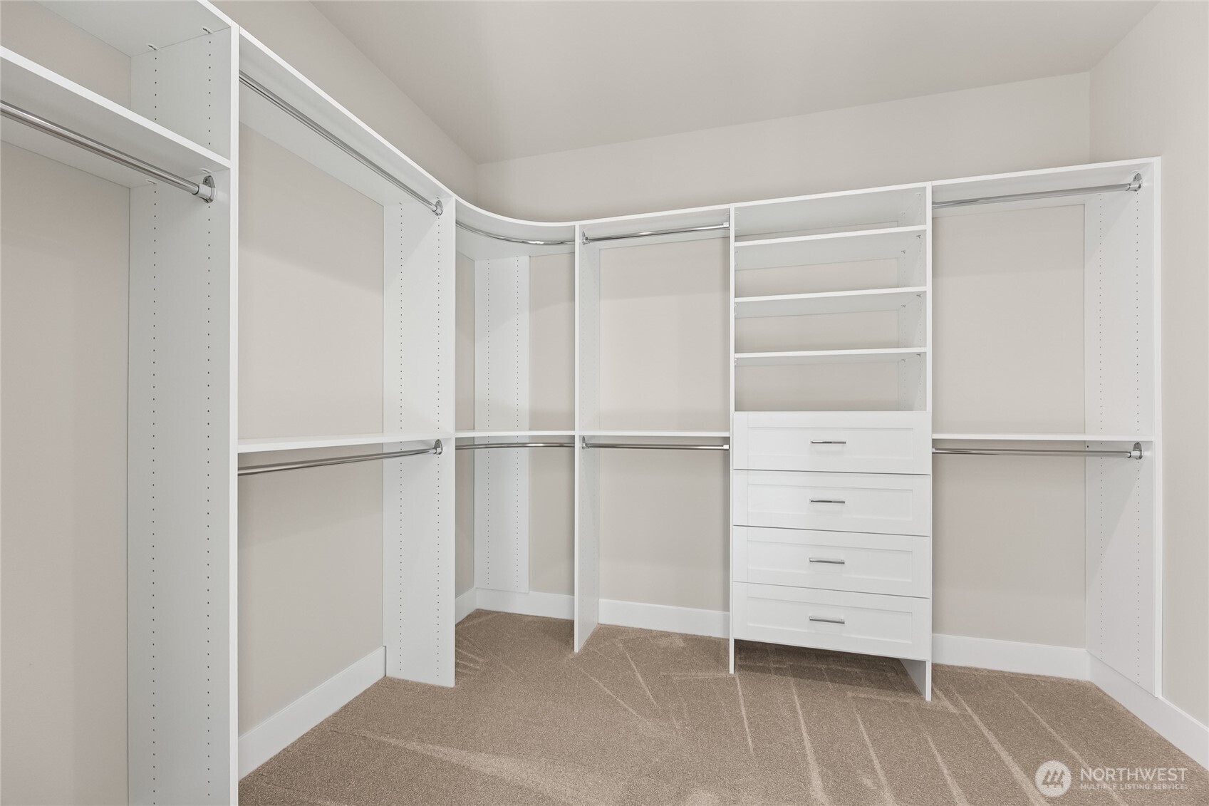 Walk in closet designed for both function and style with built in drawers, shelving and generous storage space.