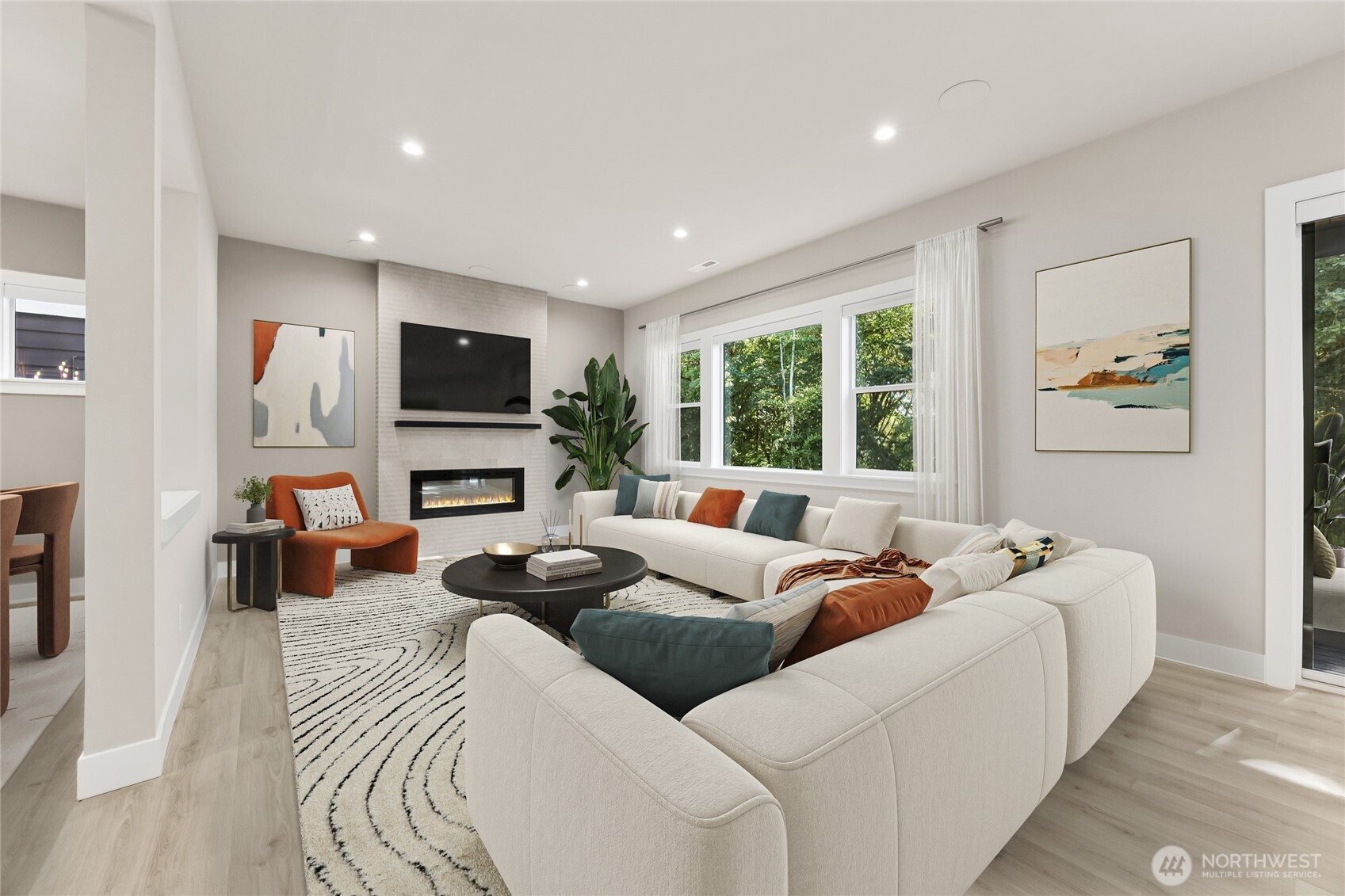 Gather in the light filled great room, where expansive windows, cozy fireplace, and seamless connection to the kitchen create the perfect space. Virtually staged.