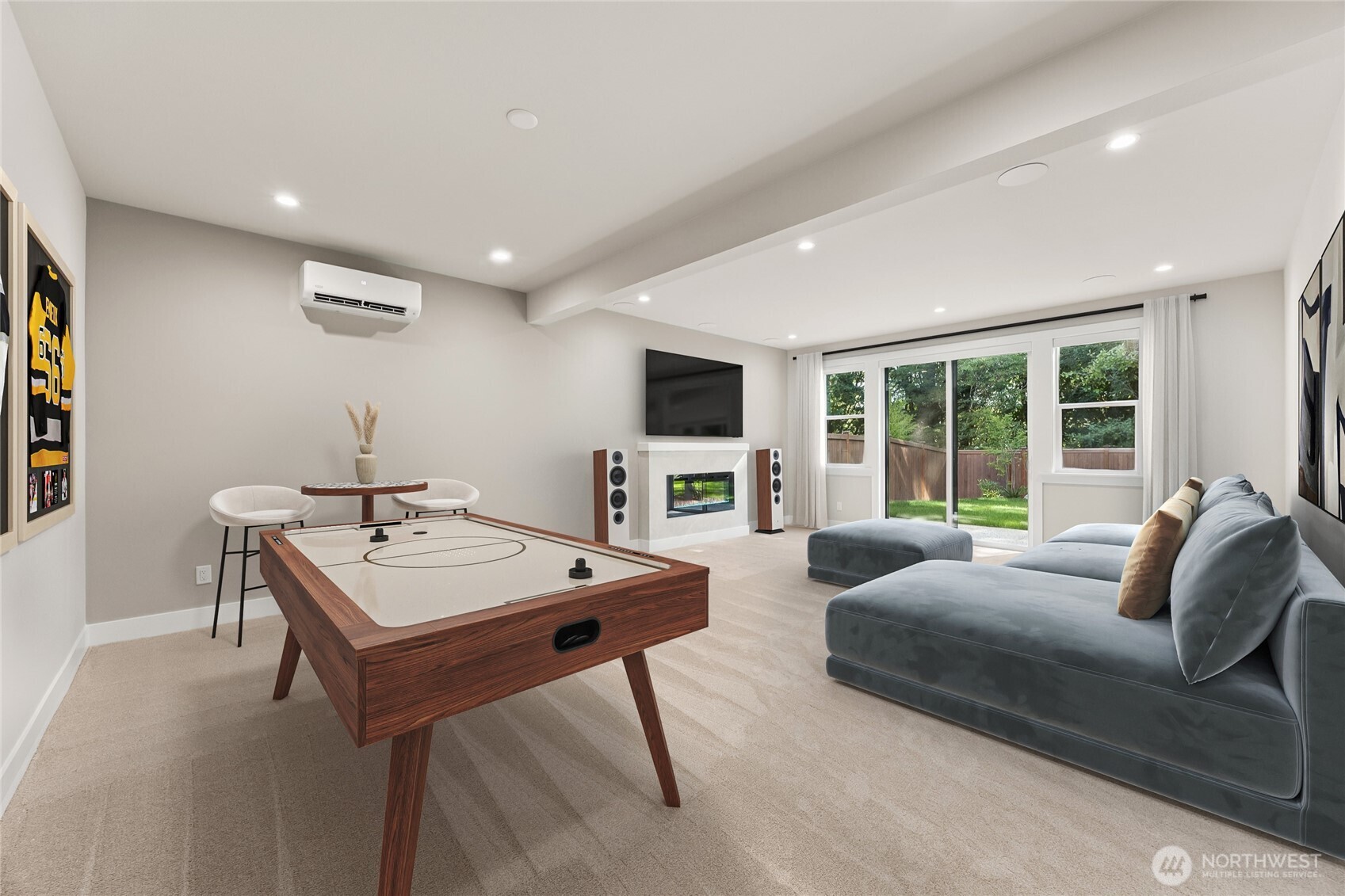 A modern electric fireplace creates a warm focal point in the spacious walkout lower-level living area. Virtually staged.