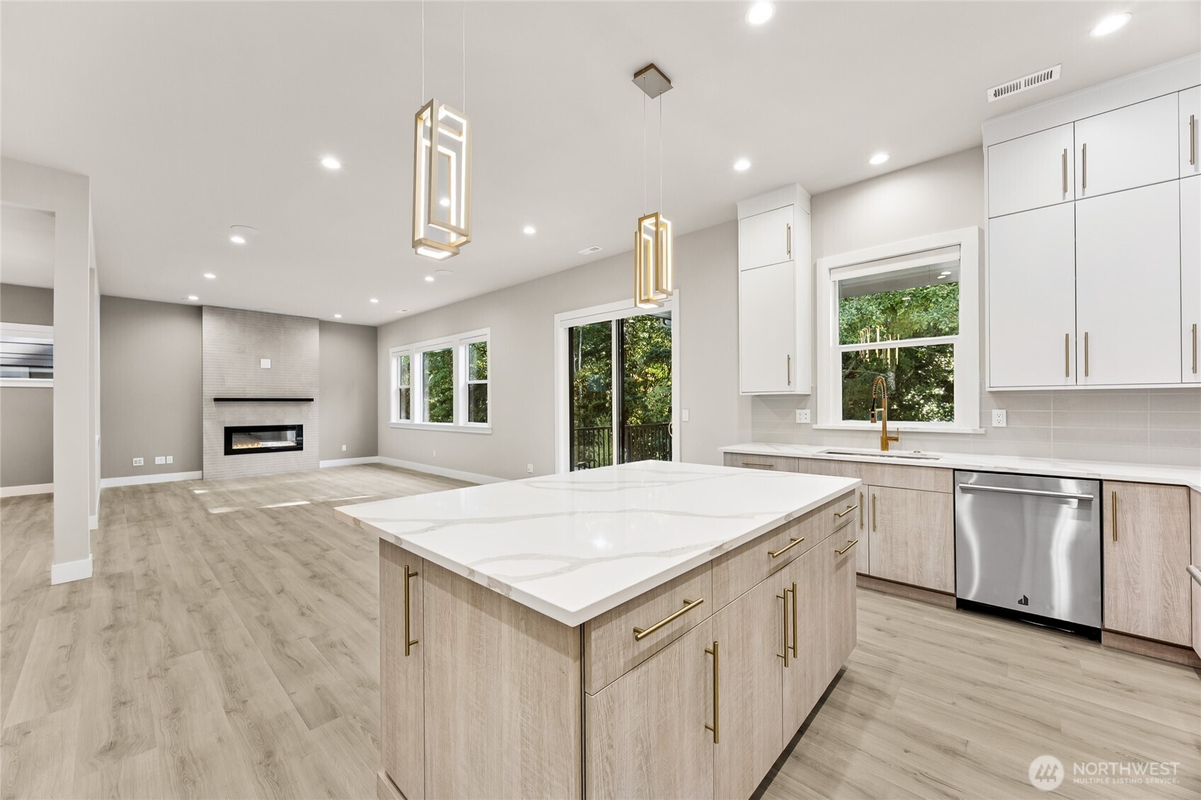 Designer finished shine through the chef's kitchen, featuring quartz countertops, contemporary two toned cabinetry, elegant lighting and premium hardware.