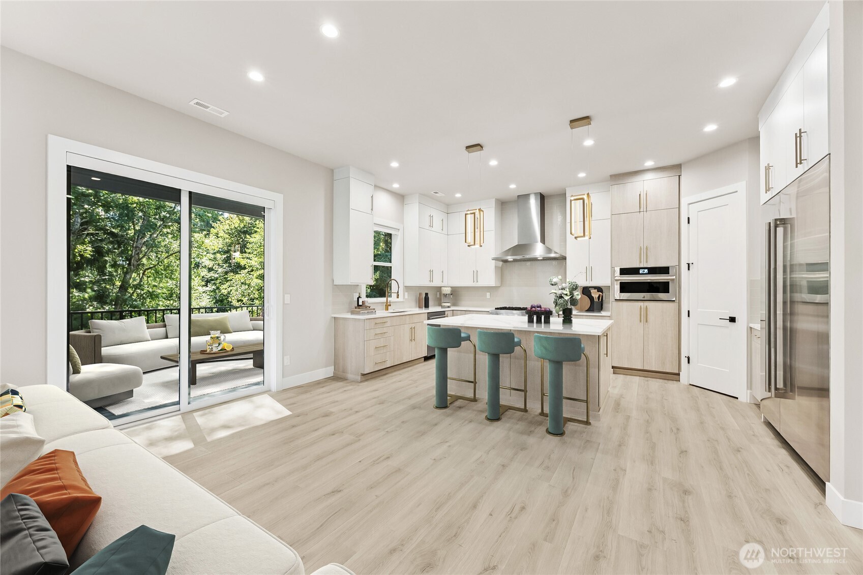 Expansive sliding glass doors open to the covered outdoor living space, creating a seamless transition for year-round entertaining and relaxation. Virtually staged.
