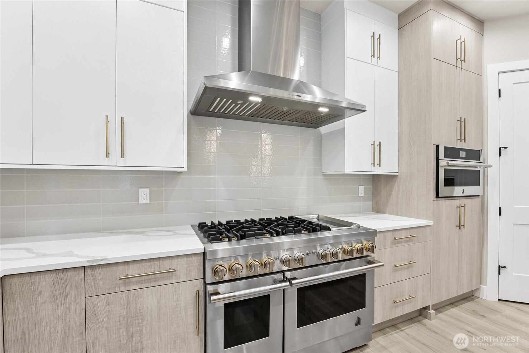 Gas range, premium stainless-steel appliances, built in appliances, and hood.