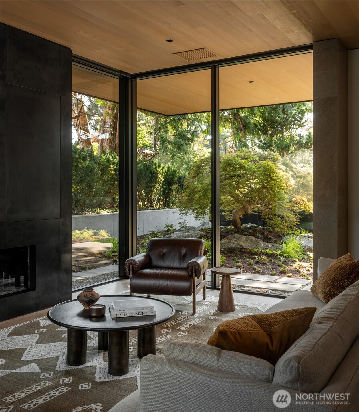 Floor-to-ceiling glass opens the living spaces to the courtyard.