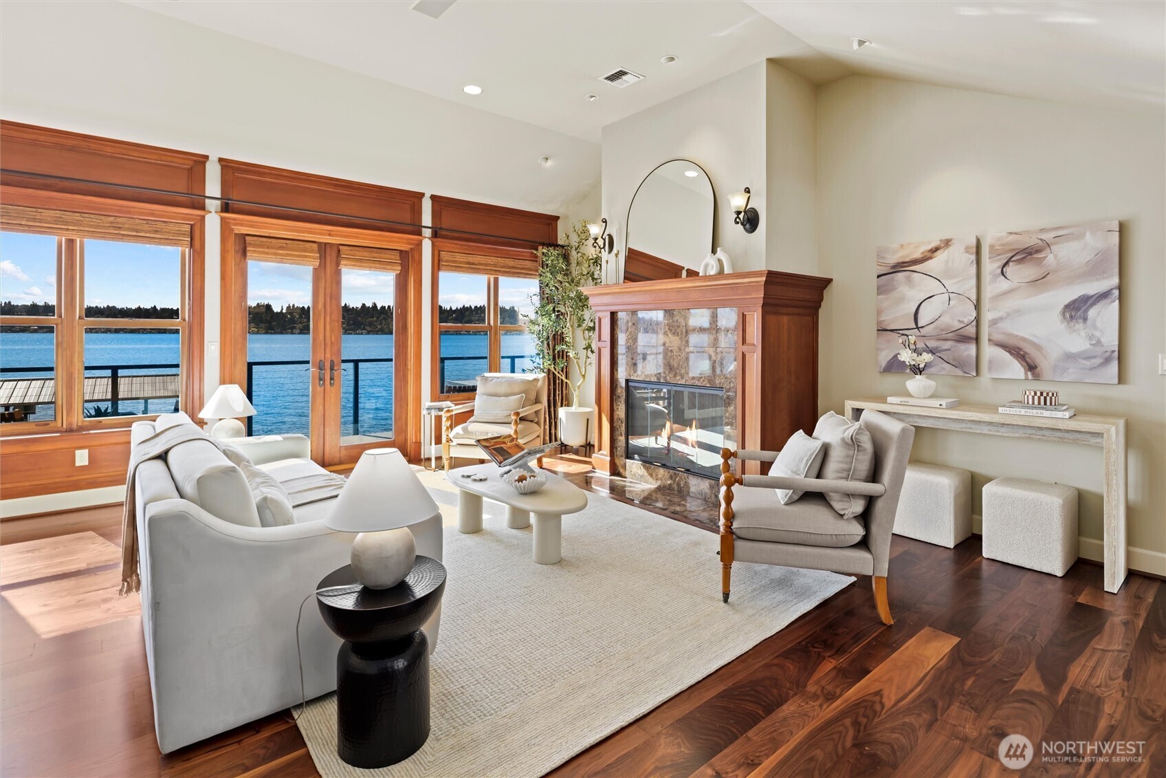 Light-filled living and dining rooms with gleaming walnut hardwoods & French doors opening directly to the incredible newly resurfaced view deck