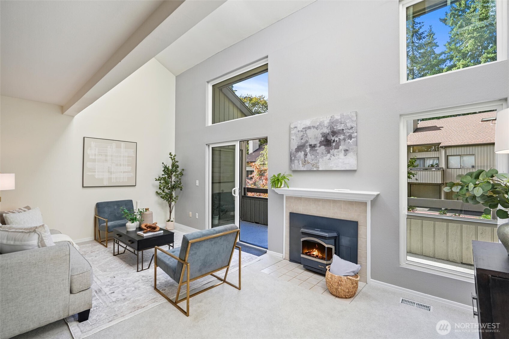Pellet-insert fireplace framed by a wall of glass offers a welcoming focal point.