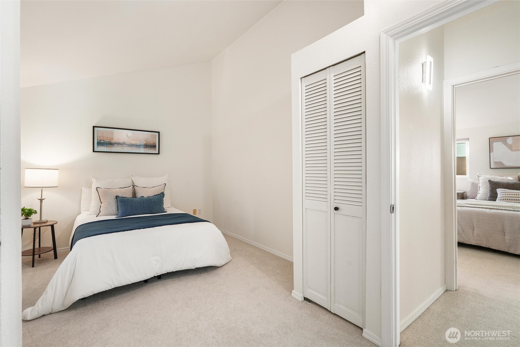 Spacious bedroom with window overlooking greenery and soft natural light