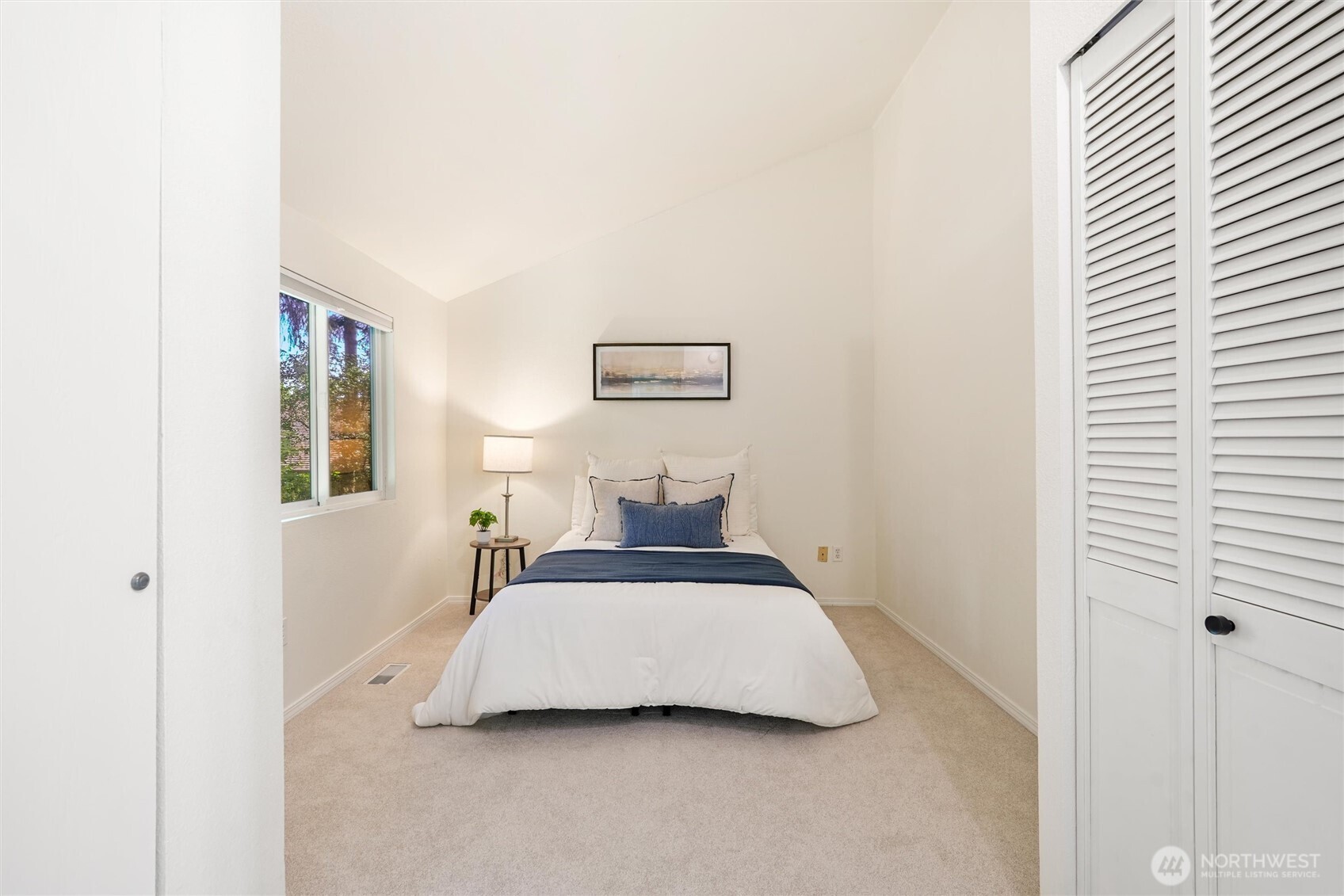 Guest bedroom with beautiful view and convenient bathroom entry.