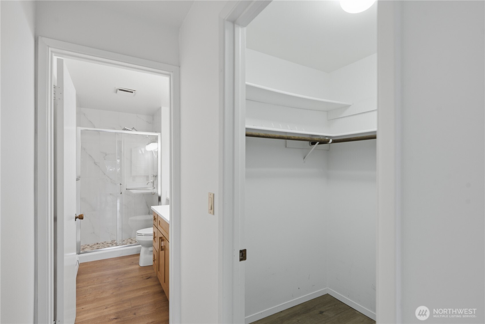 Primary bedroom with walk in closet and updated 3/4 bath.