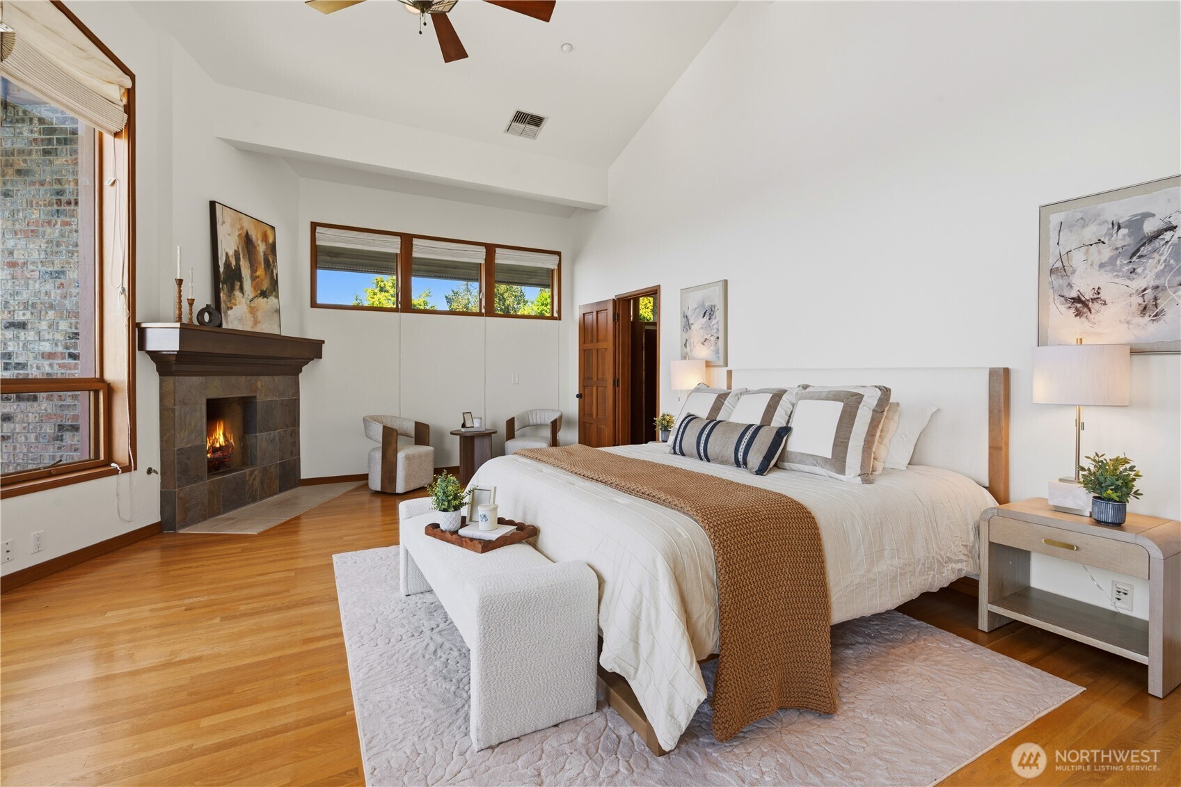 Luxury Primary Suite with ceiling fan & private view deck.