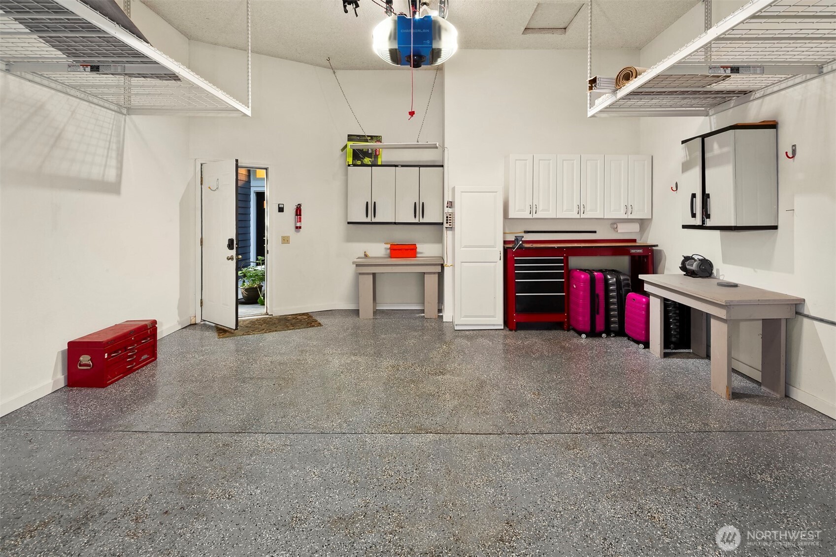 Convenient work space and storage in this two car garage, notice the poly-coated floor!