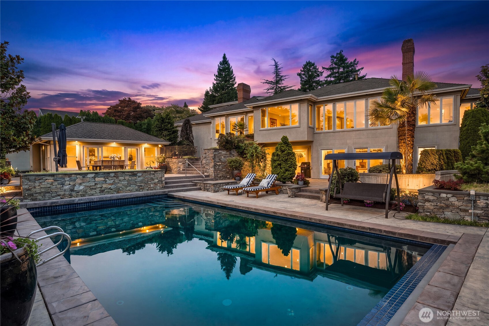 An extraordinary private estate featuring a sparkling pool, expansive outdoor entertaining spaces, lush landscaping, and timeless architecture.