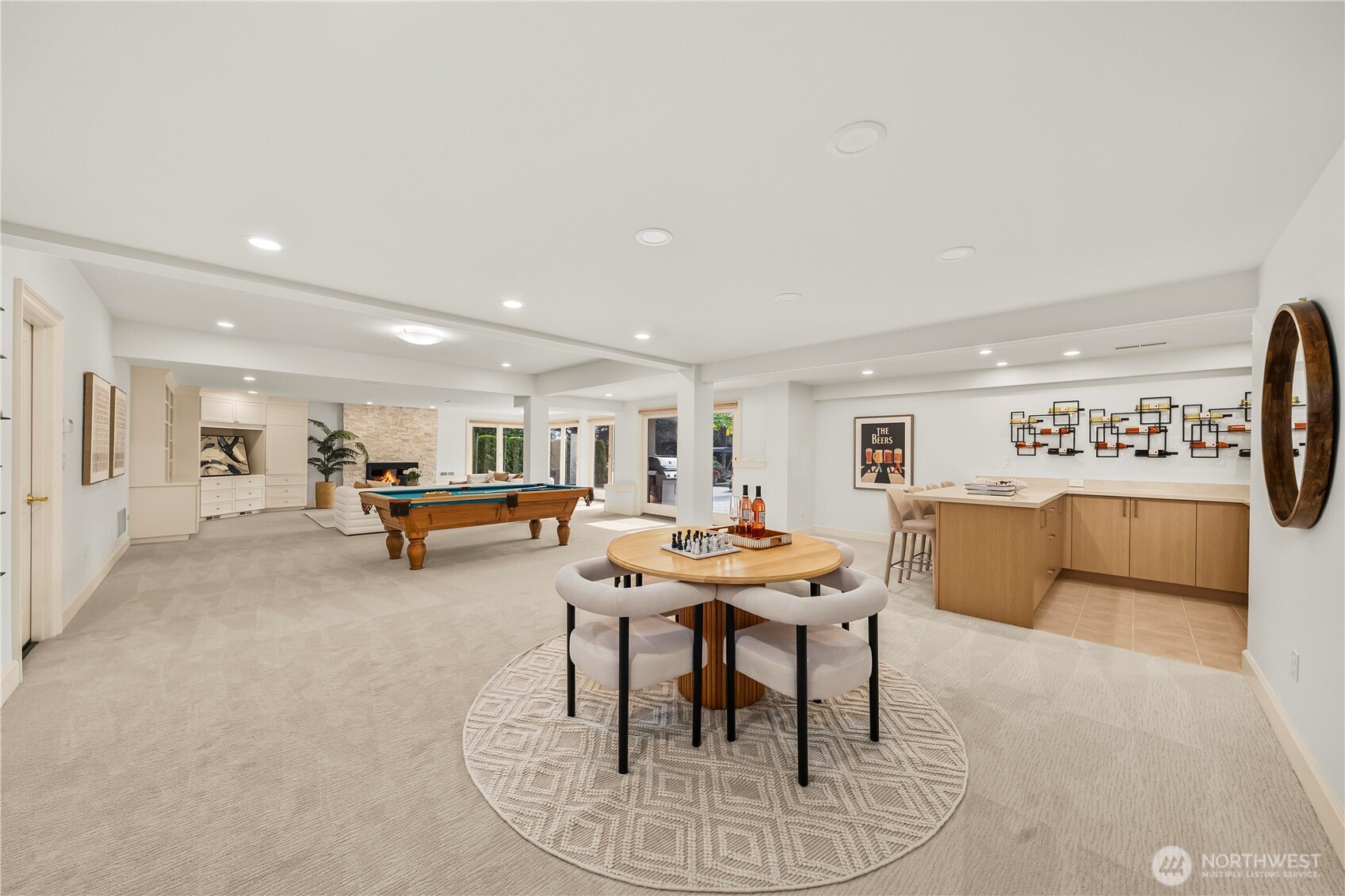 Spacious entertainment retreat with billiards, game area, wet bar, fireplace, and seamless access to the backyard and pool.