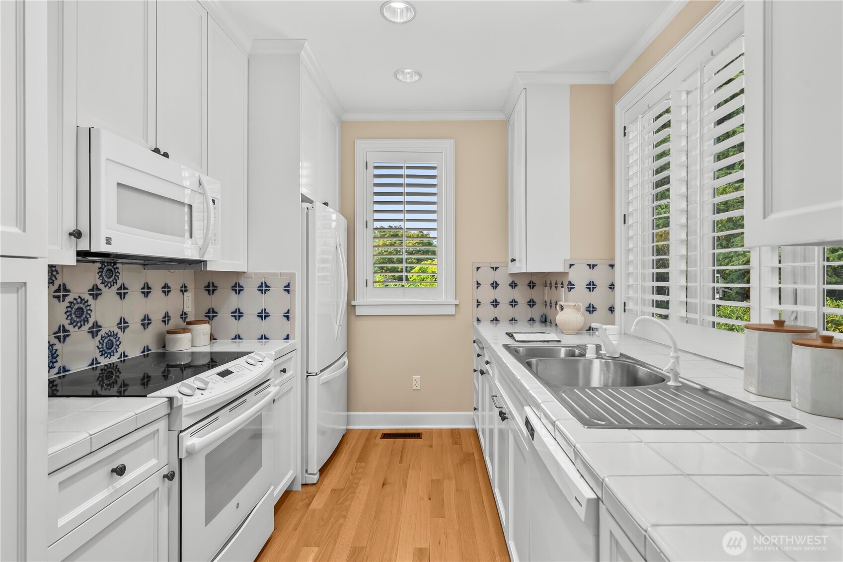 Bright, fully equipped kitchen with abundant cabinetry, natural light, and everything needed for comfortable independent living