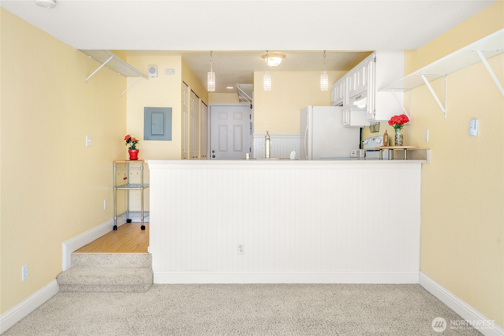 Studio living area looking toward the kitchen and breakfast bar.