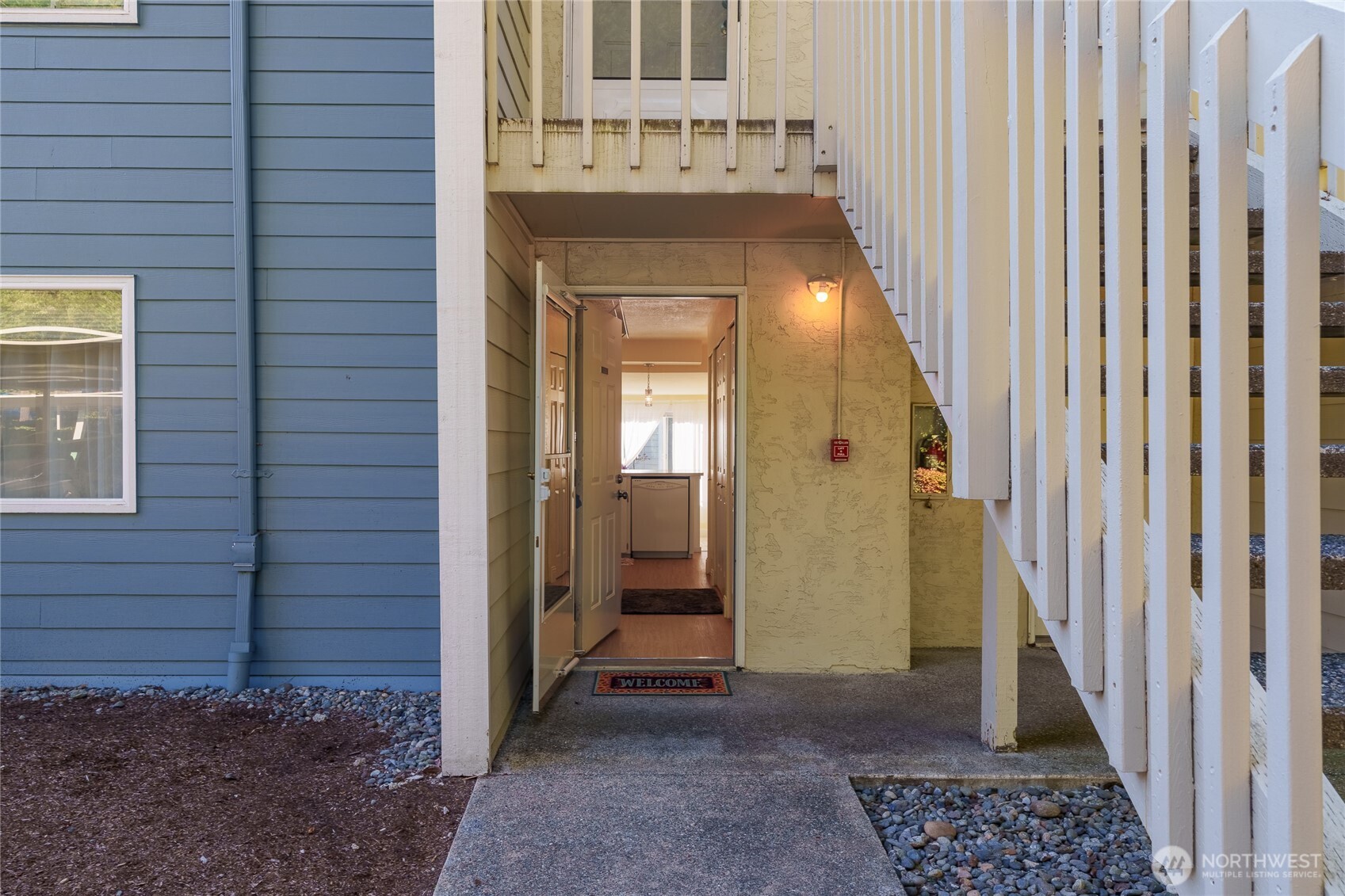 Covered exterior approach to the unit entrance.