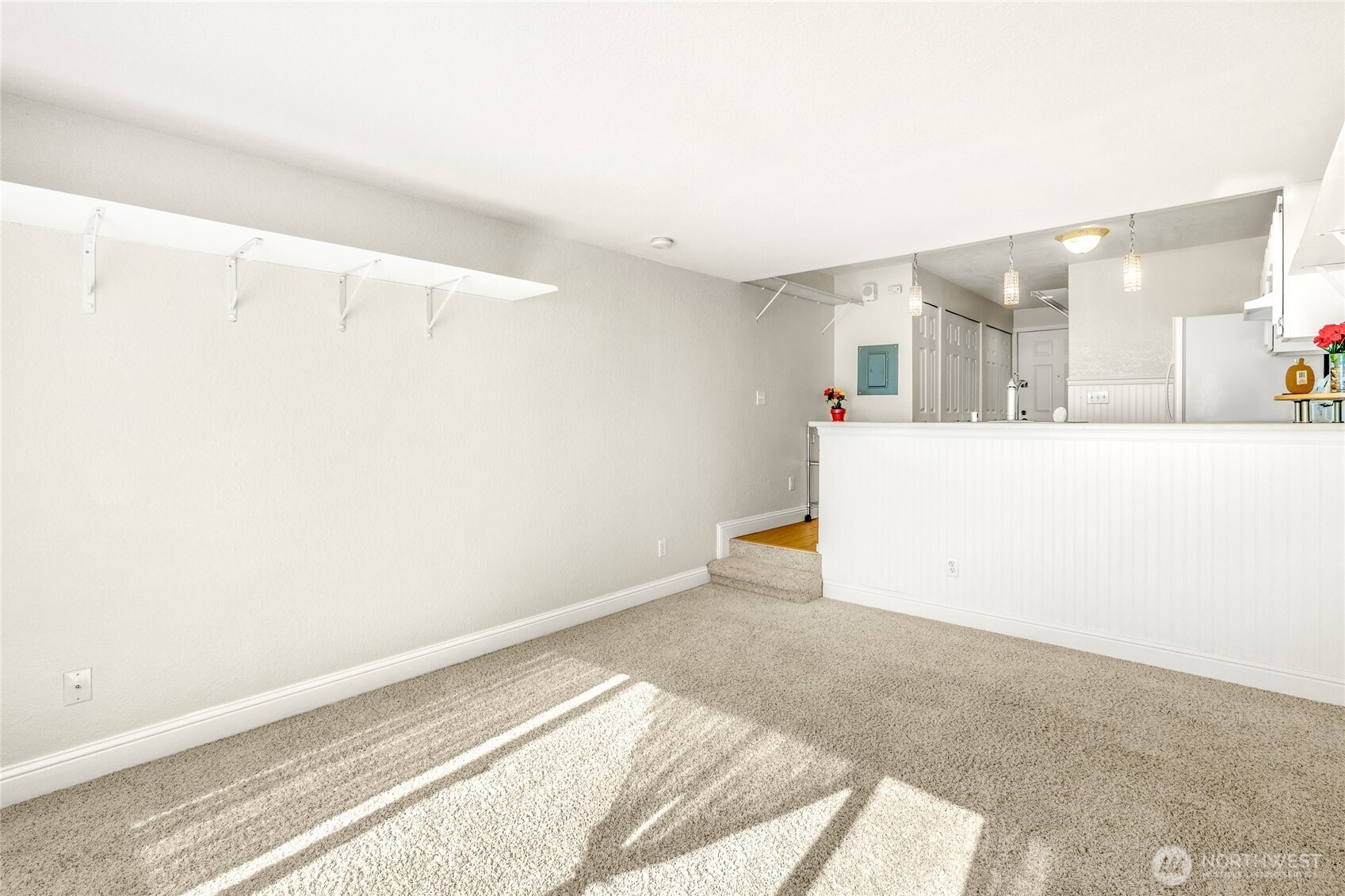 Built-in pantry and storage shelving located near the kitchen and entry.